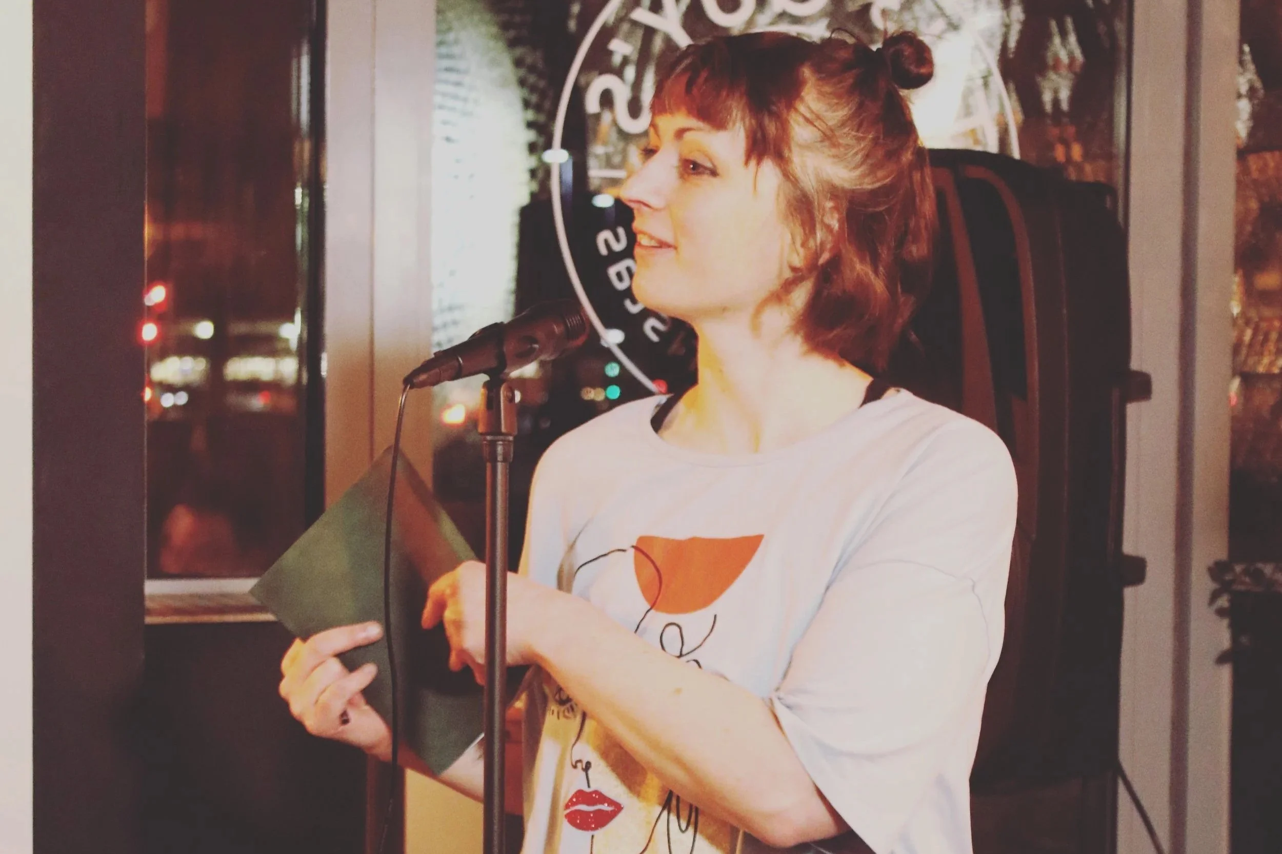 profile picture of emily holding a poetry book
