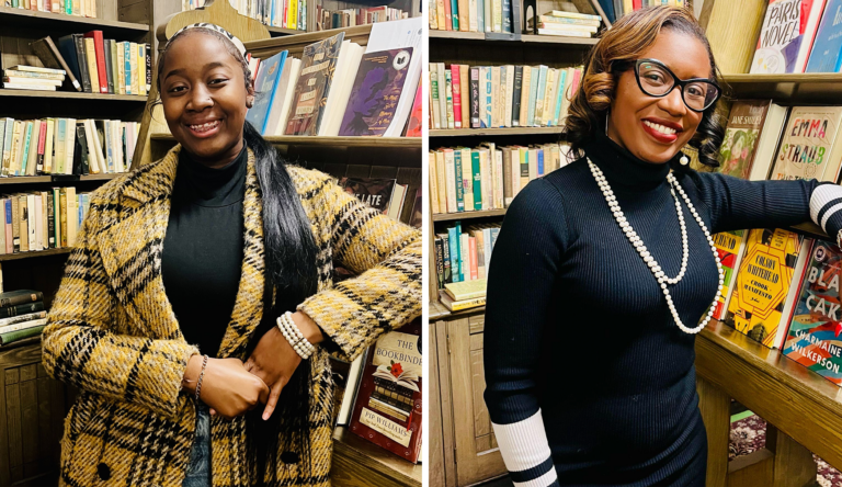 Two women standing in front of bookshelves filled with books in a bookstore. The woman on the left wears a yellow and black plaid coat, a black turtleneck, and has long black hair. The woman on the right wears a black sweater with white stripes on the sleeves, glasses, a pearl necklace, and has shoulder-length wavy hair.