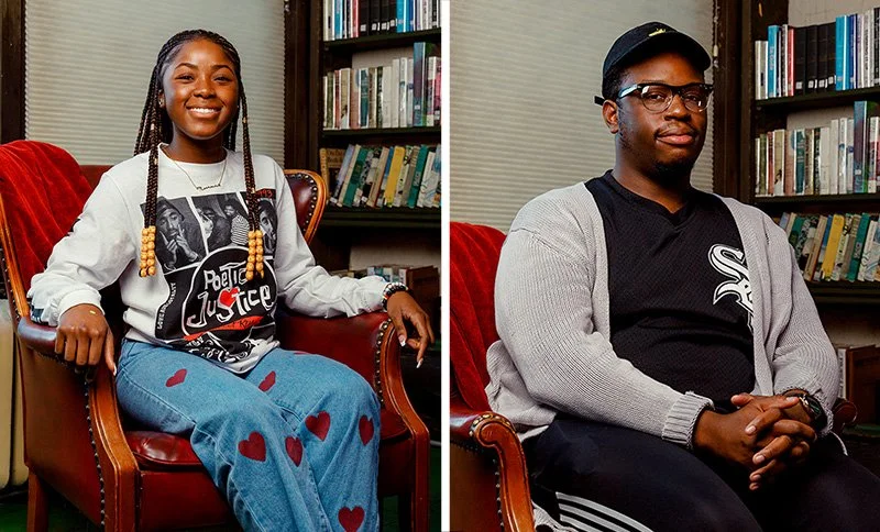 Two young adults sitting in chairs in front of bookshelves, smiling. The woman on the left has braids with beads, is wearing a white sweatshirt with graphic and red hearts on her jeans. The man on the right has glasses, a cap, and a gray cardigan over a black shirt with a white logo.