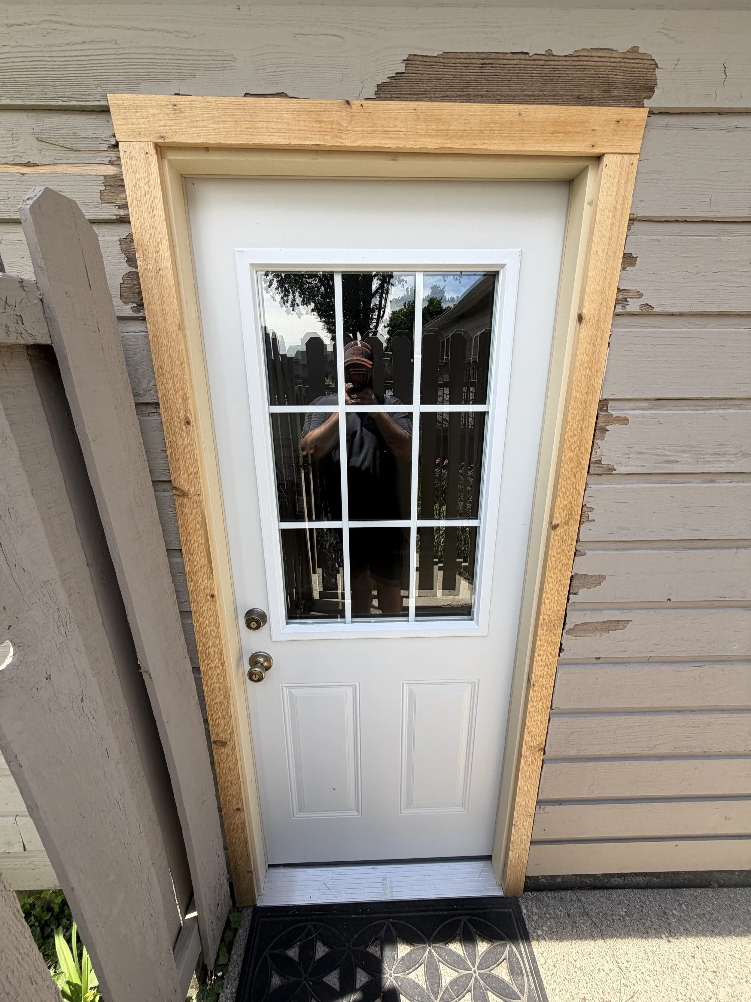 Energy efficient insulated steel door with cedar molding.