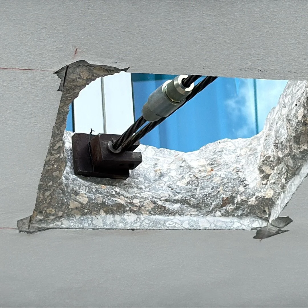 Ceiling with a hole showing mechanical equipment and blue sky outside.