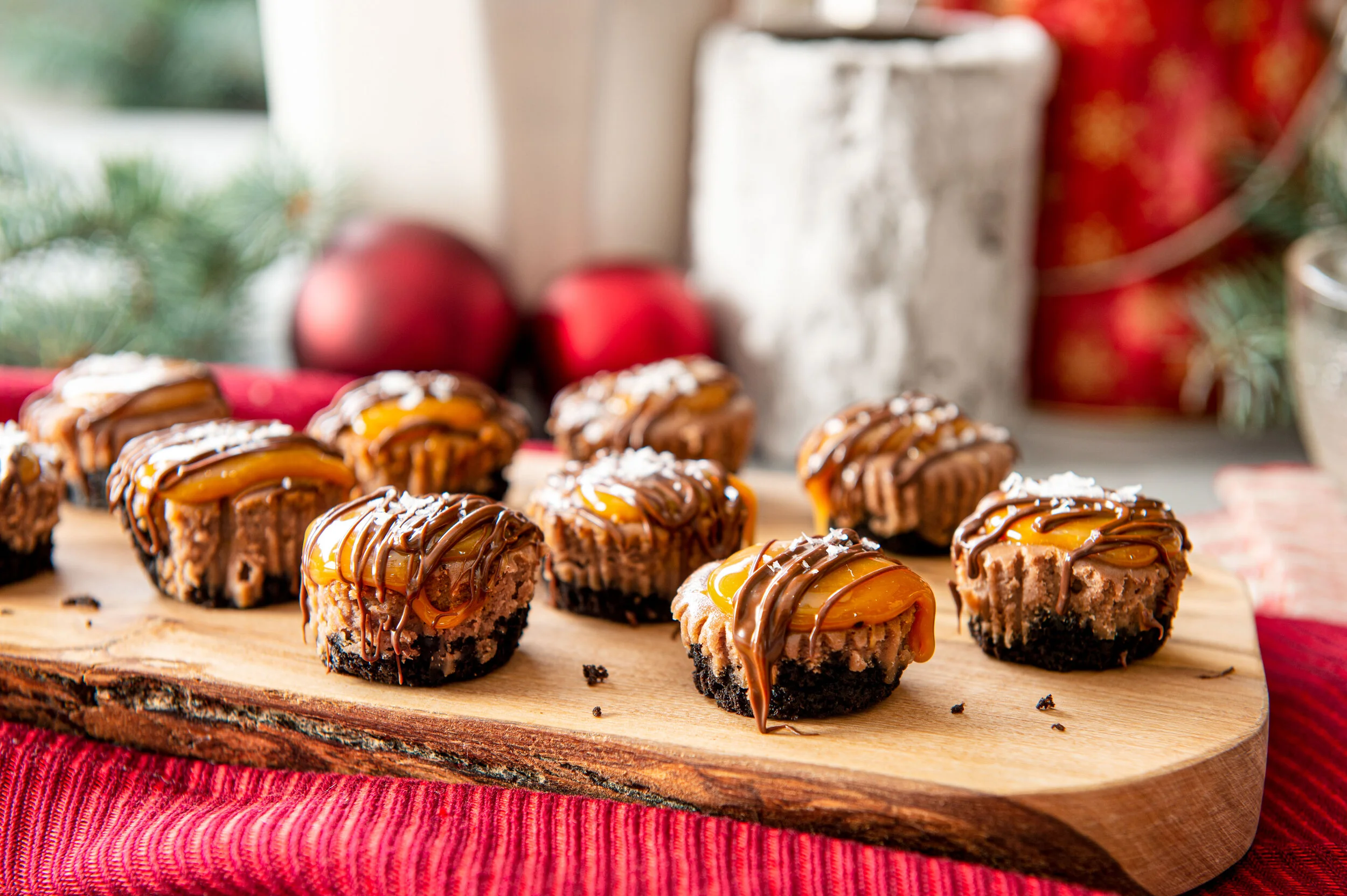  A wooden chopping board of small caramel brownie bites sit amongst festive decorative cues. Food photography by El Keegan, Dublin.  