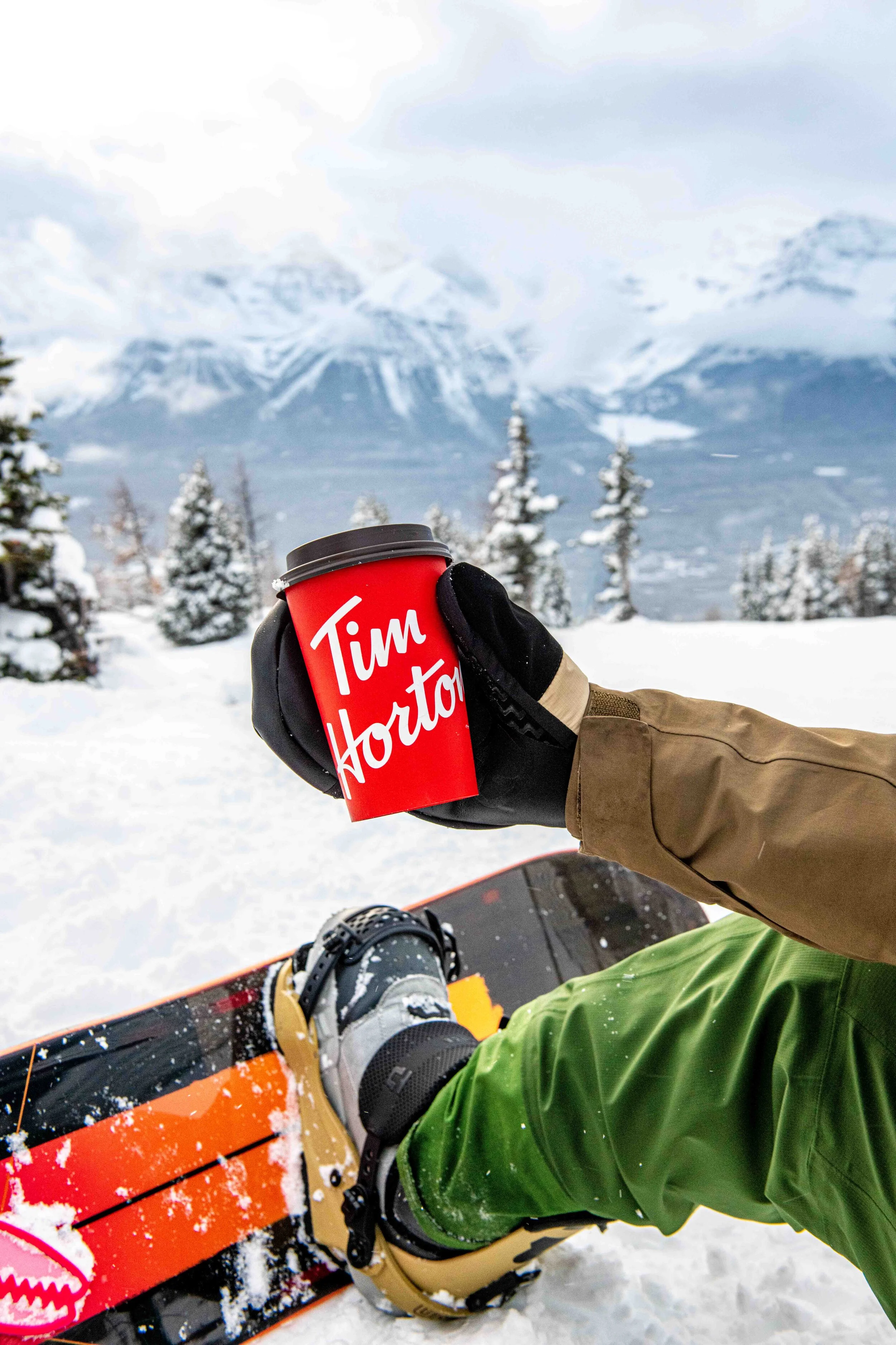  A cup of coffee enjoyed on the top of Lake Louise Ski Resort by a snowboarder. Photographed by Lifestyle Photographer, El Keegan.  