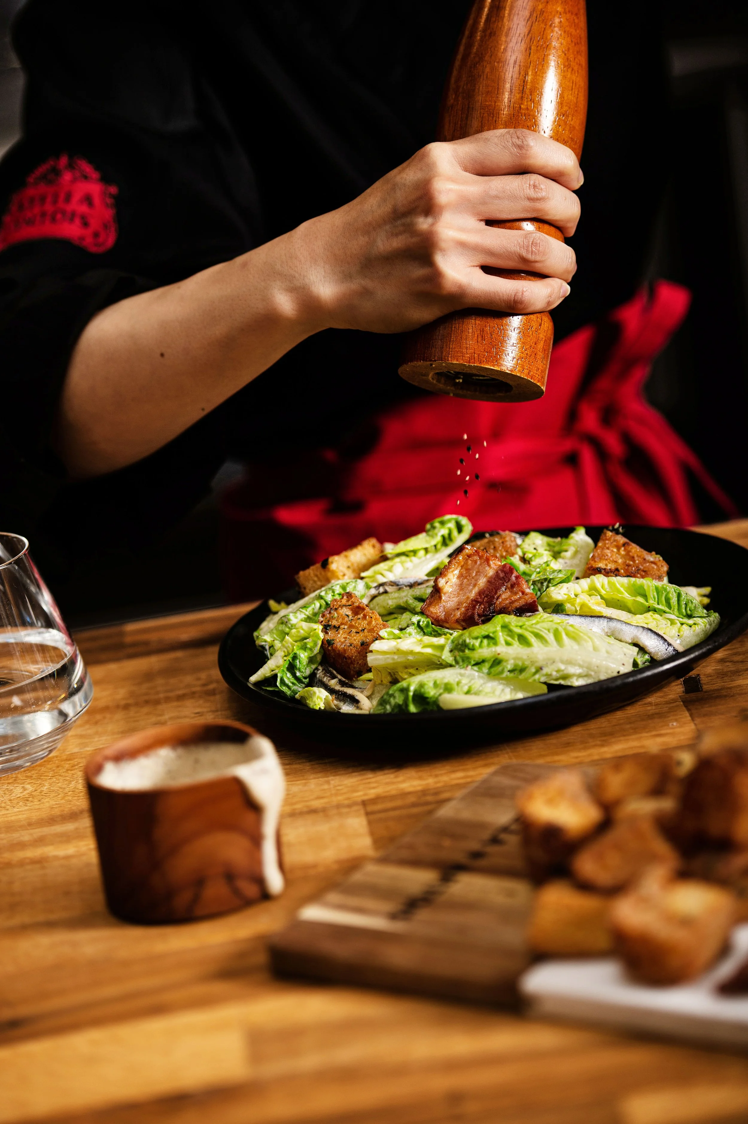  An action photograph of a chef grinding pepper on a caesar salad for Stella Artois. Commercial photo taken by Dublin Lifestyle Photographer, El Keegan.  