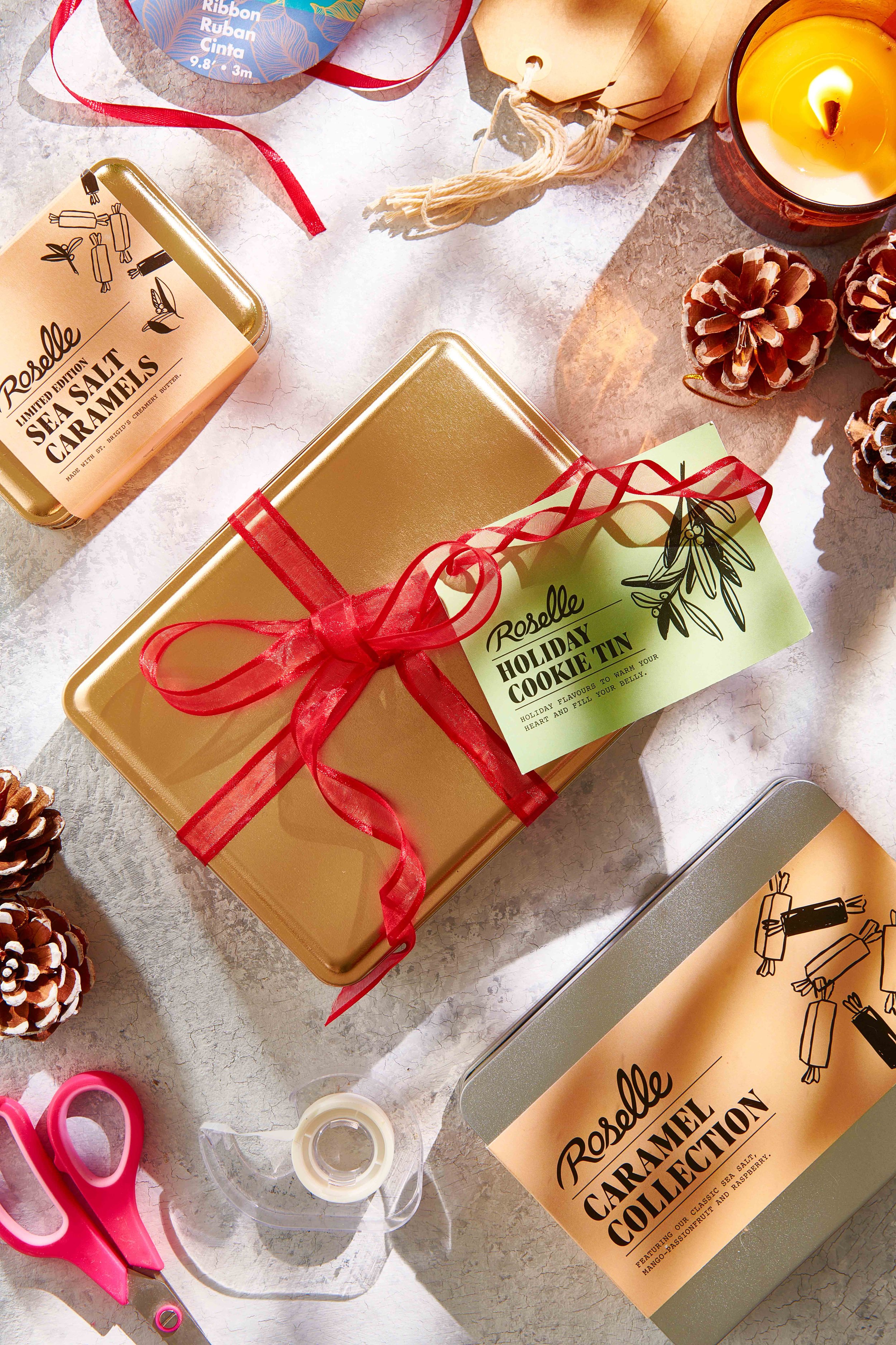   A group of gold and silver tins wrapped in ribbons getting ready to be gifted. Photography by El Keegan, Dublin, Ireland.  