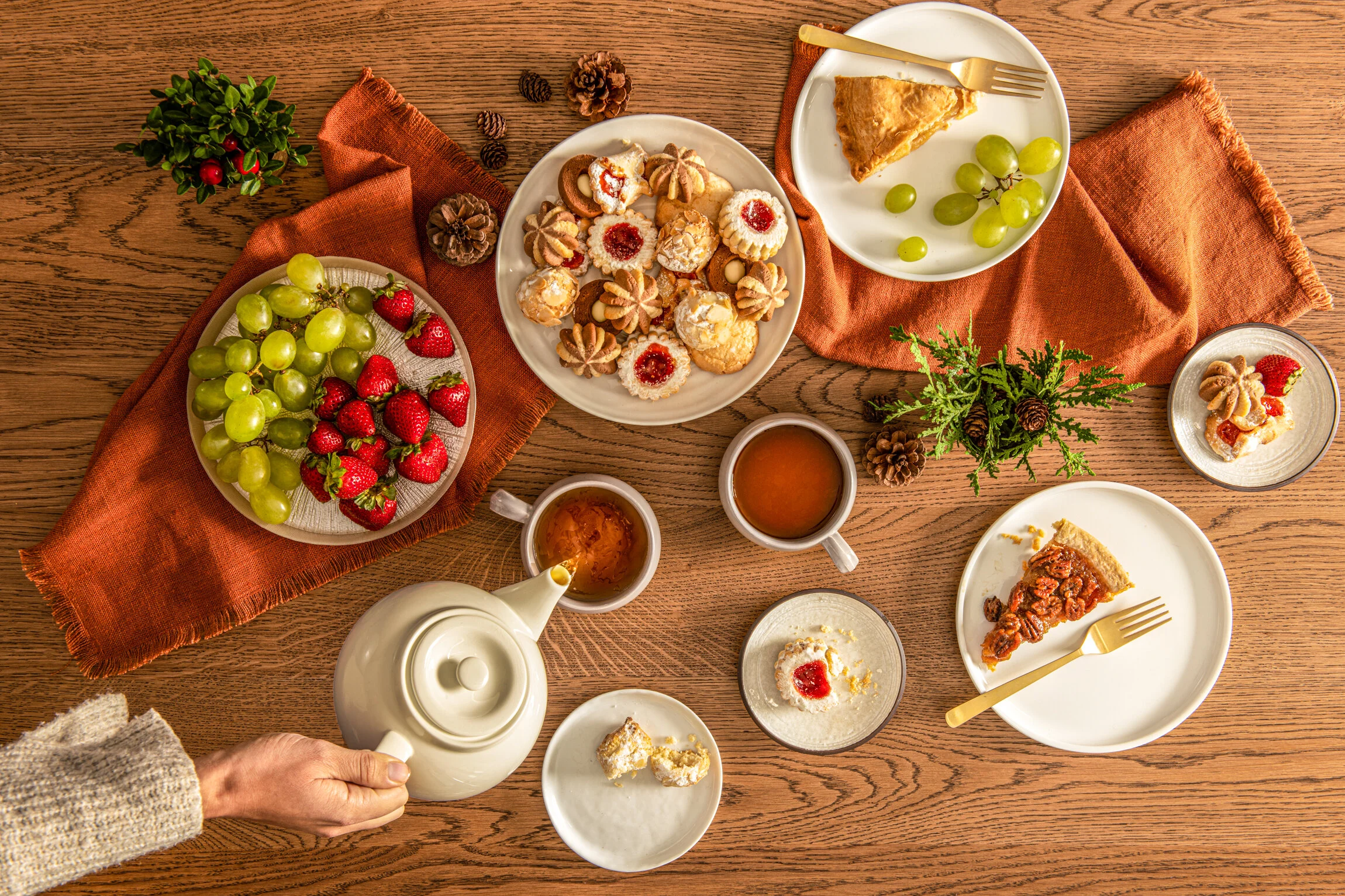  A festive table is laid out with freshly poured tea, biscuits, fruit and other deserts. Photography by El Keegan, Dublin, Ireland.  