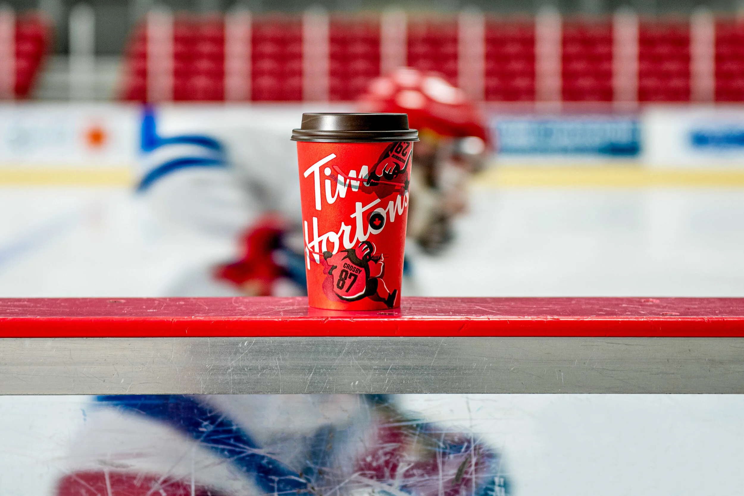  A hockey player speeds passed a cup of Tim Hortons coffee on the sideline. Commercial drinks photography created by Irish Photographer, El Keegan.  