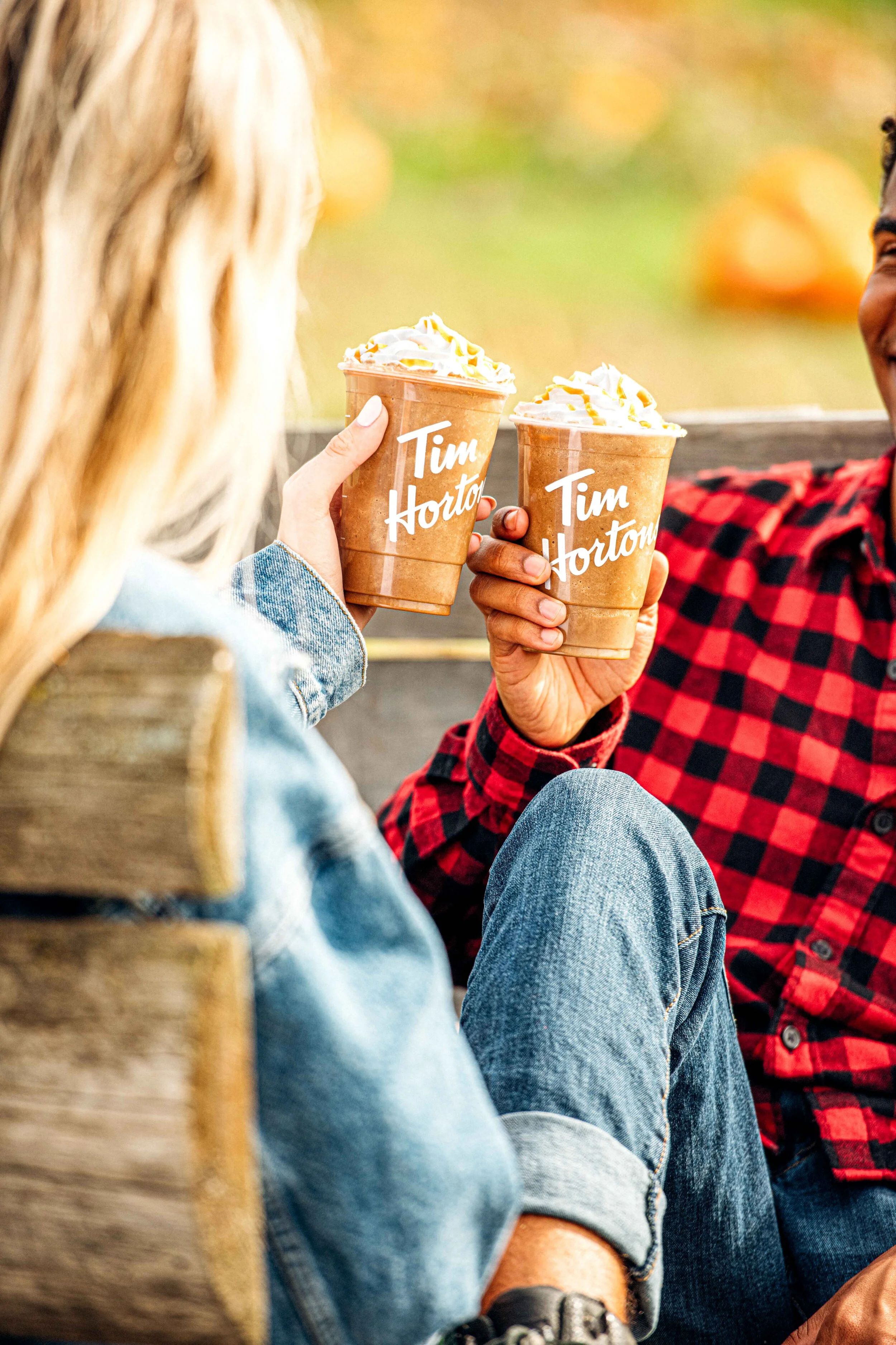  A lifestyle photograph of two people enjoying Tim Hortons Iced Lattes on a pumpkin farm. Food photography by El Keegan, Ireland.  