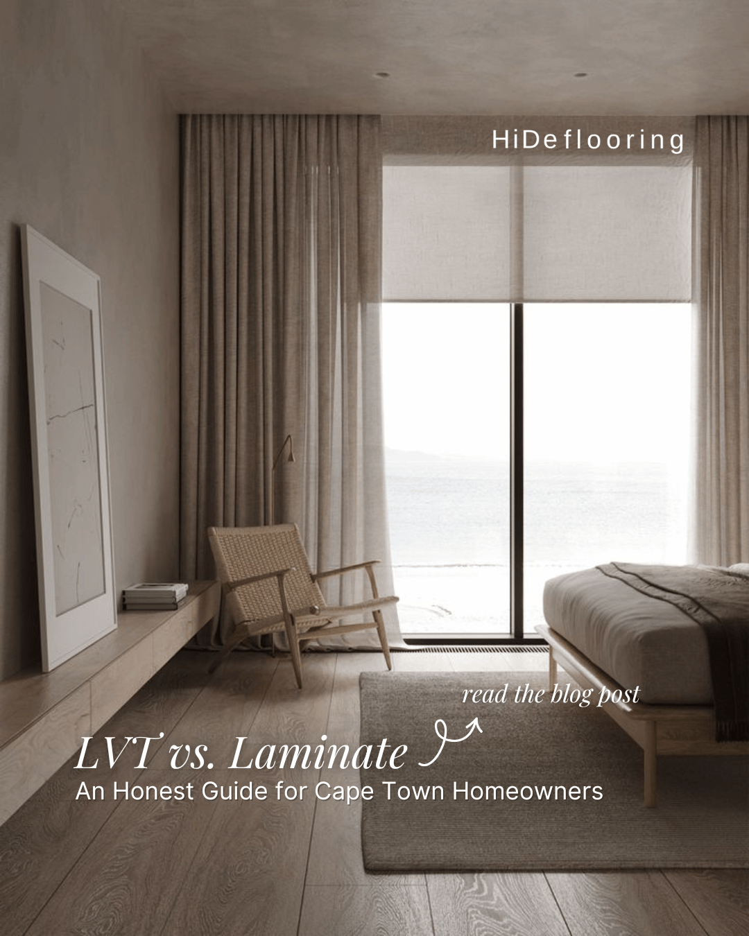 A bedroom with large window and beige curtains, a bed, a woven chair, a small table, and a large abstract painting leaning against the wall. The image promotes Hideflooring expertise in blinds