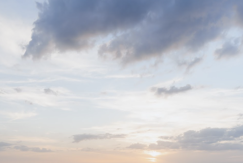Sunset or sunrise sky with clouds and hints of sunlight