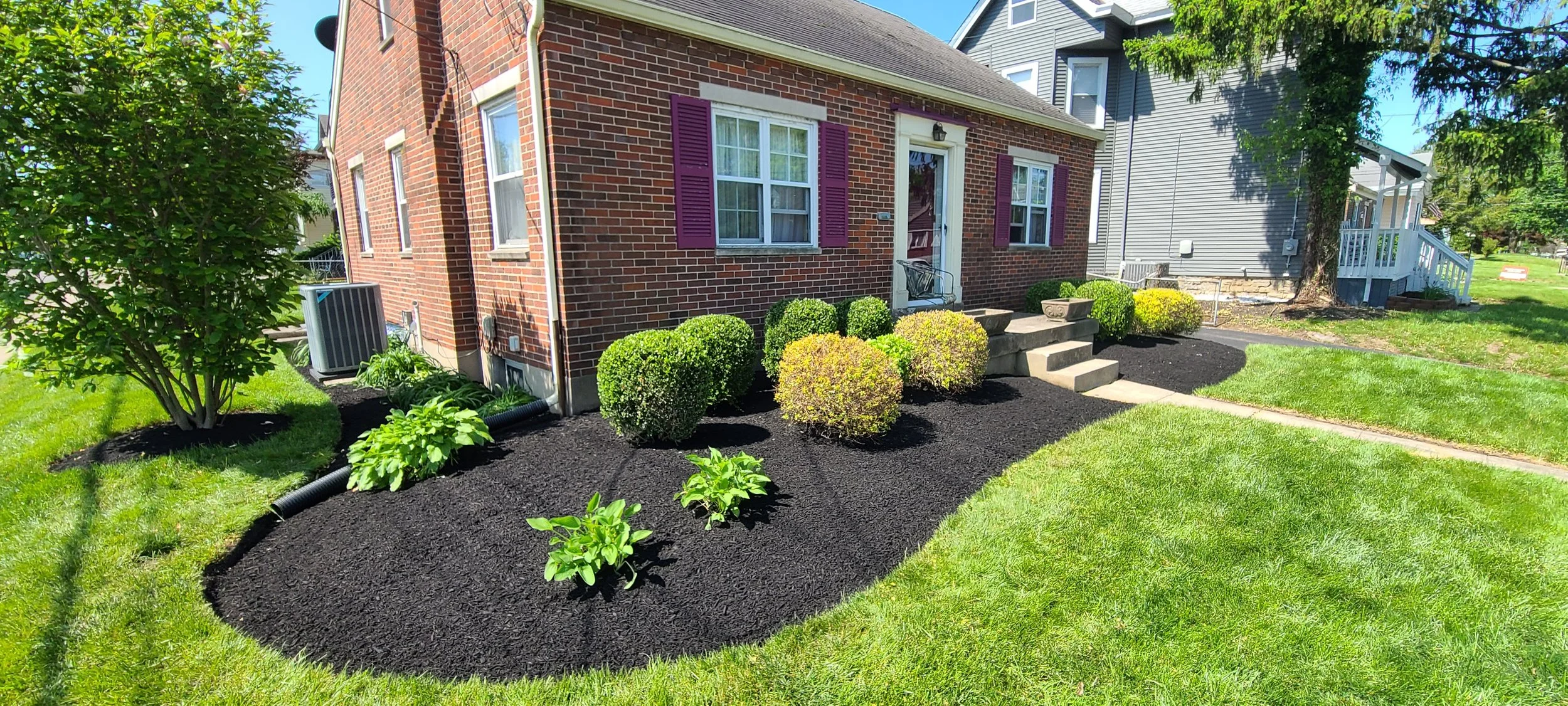 After view of residential landscape beds cleaned, edged, trimmed, and refreshed with dark mulch.