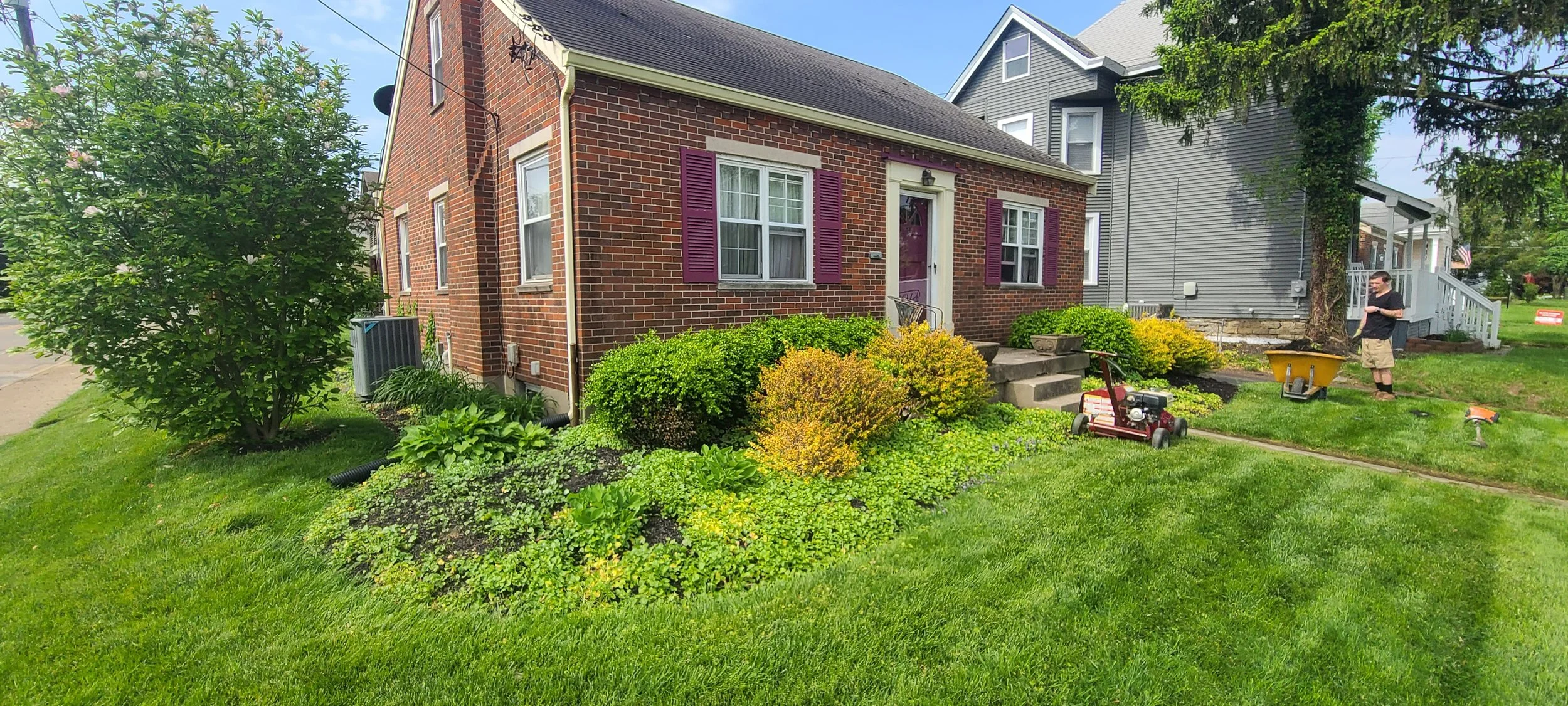 Before view of residential landscape beds needing cleanup, edging, trimming, and mulch refresh.