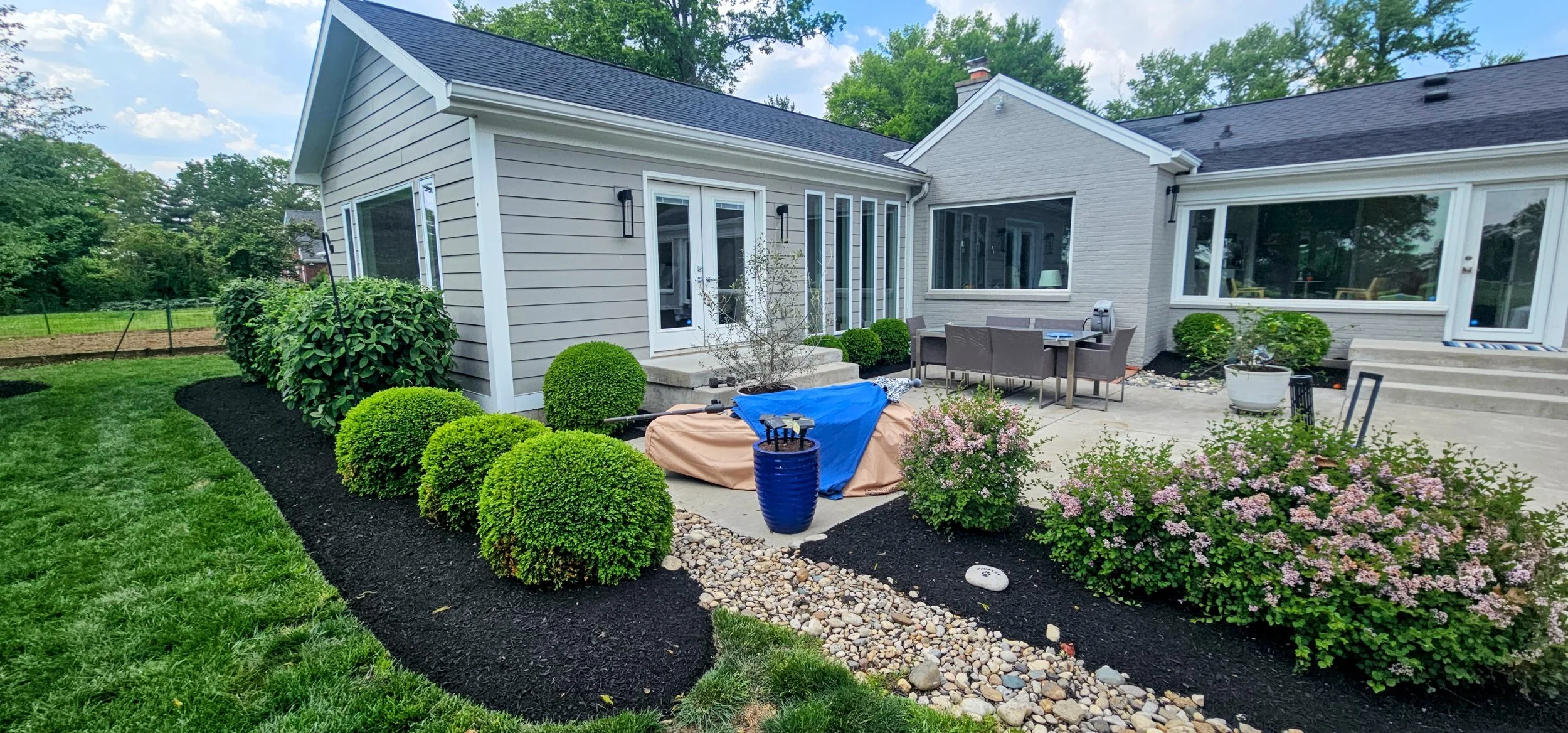 Cleaned and refreshed front garden beds with dark mulch, shaped shrubs, and finished landscape detail.