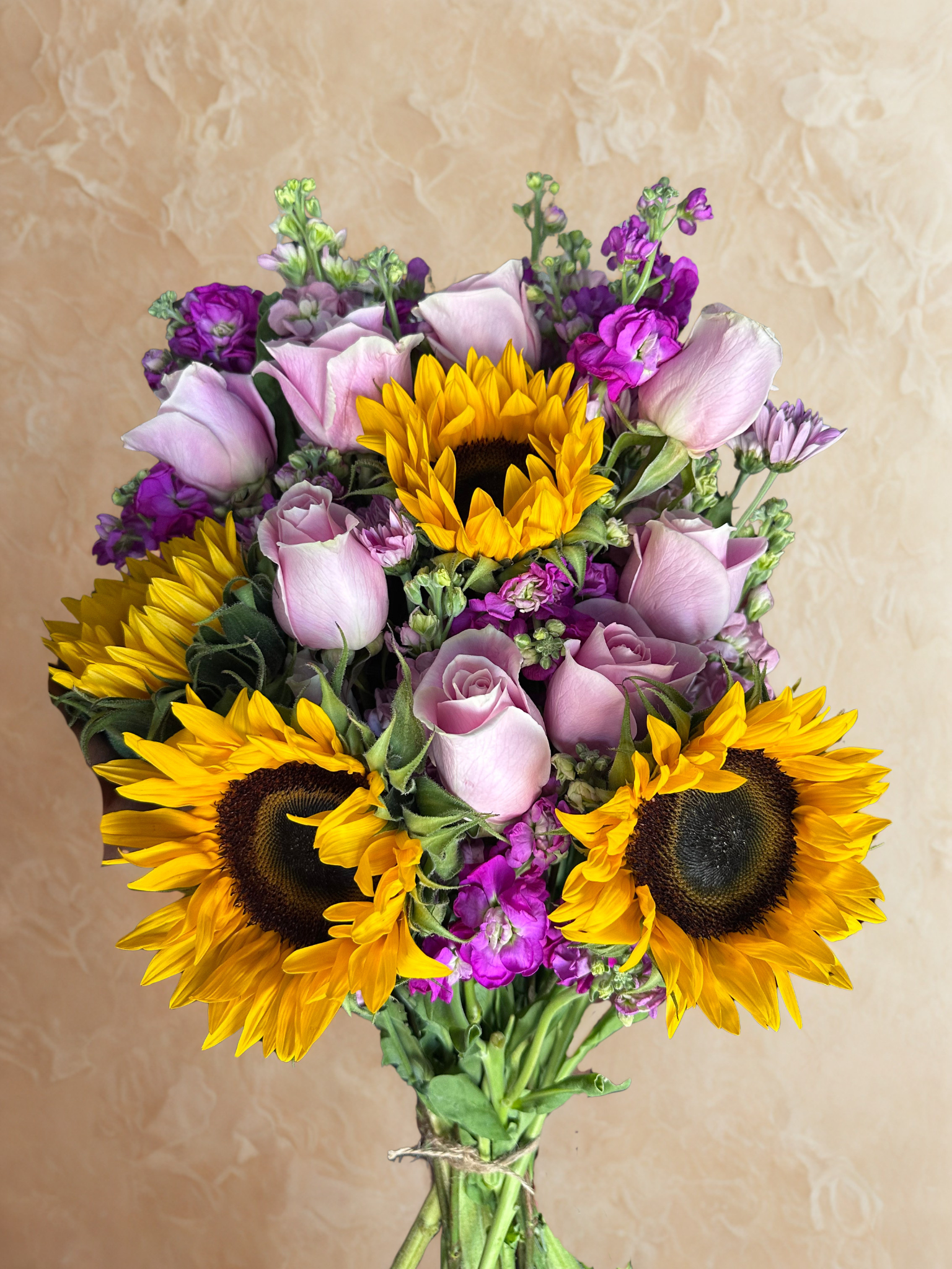 Custom floral arrangement featuring roses and sunflowers, created by a Black queer woman florist in the Washington DC and greater DMV area