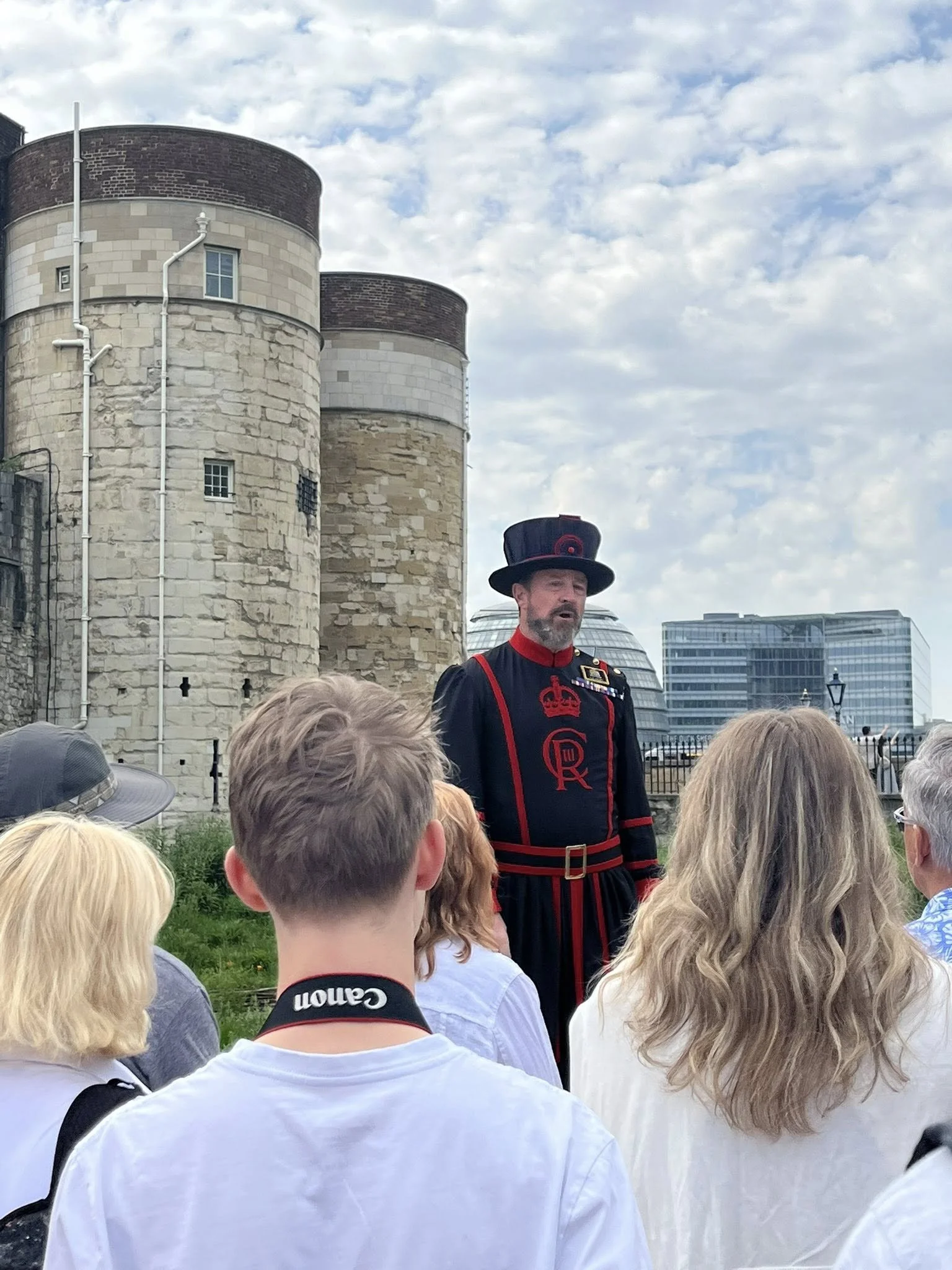 This is a photograph of one of the Beefeaters, or official guards, giving the Beefeater Tour at the Tower of London in England