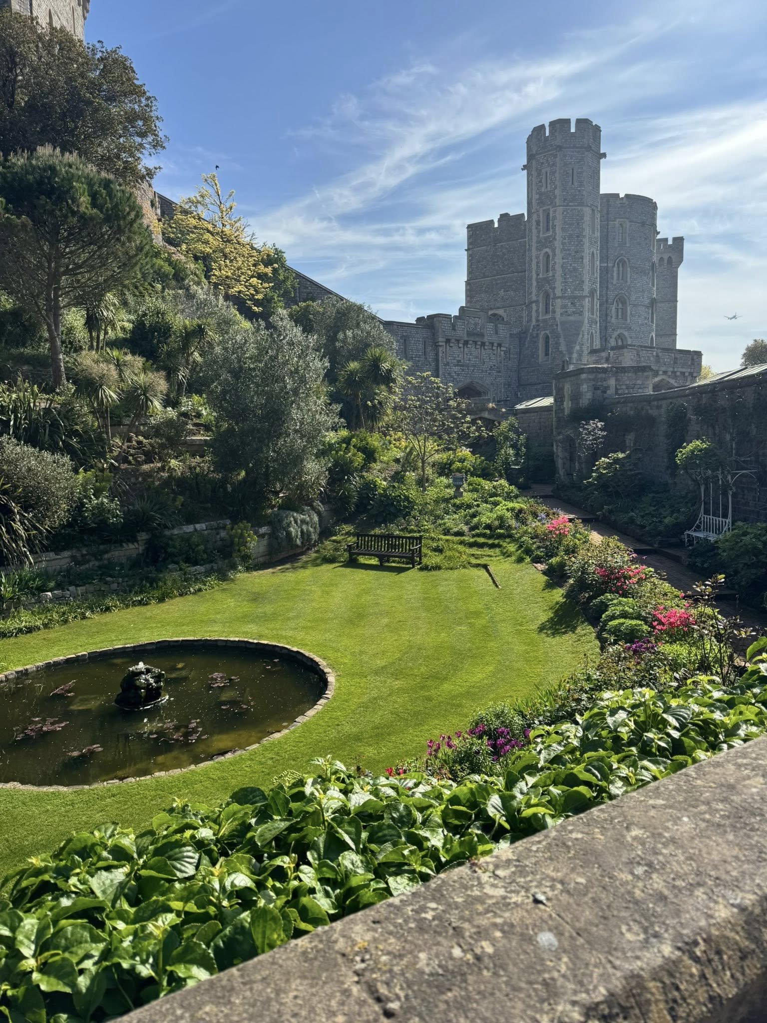 A view of the exterior of Windsor Castle near London featuring the beautiful gardens