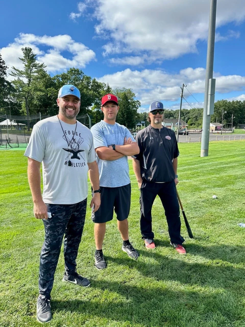 Coaches standing in baseball field