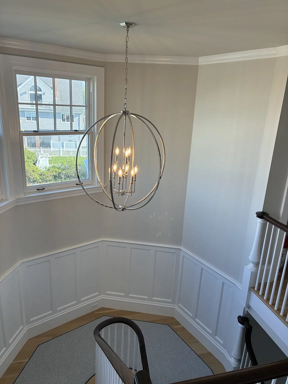 Residential chandelier and stair lighting installed by Source Electric in Rhode Island