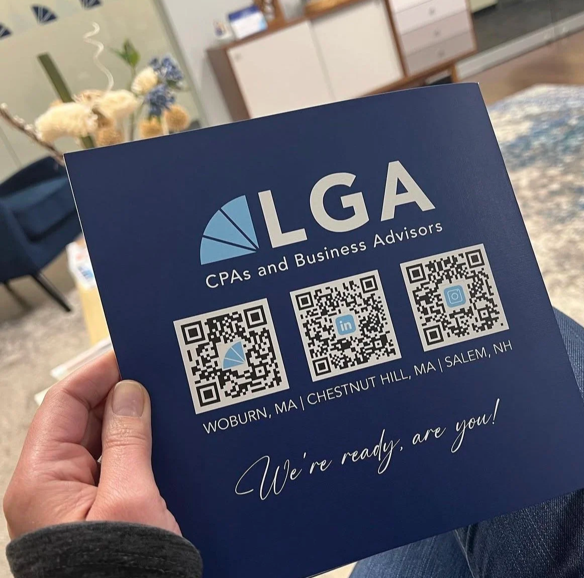 Blue business card for LGTA CPAs and Business Advisors with QR codes for website, LinkedIn, and Instagram, and text indicating locations in Woburn, MA, Chestnut Hill, MA, and Salem, NH.