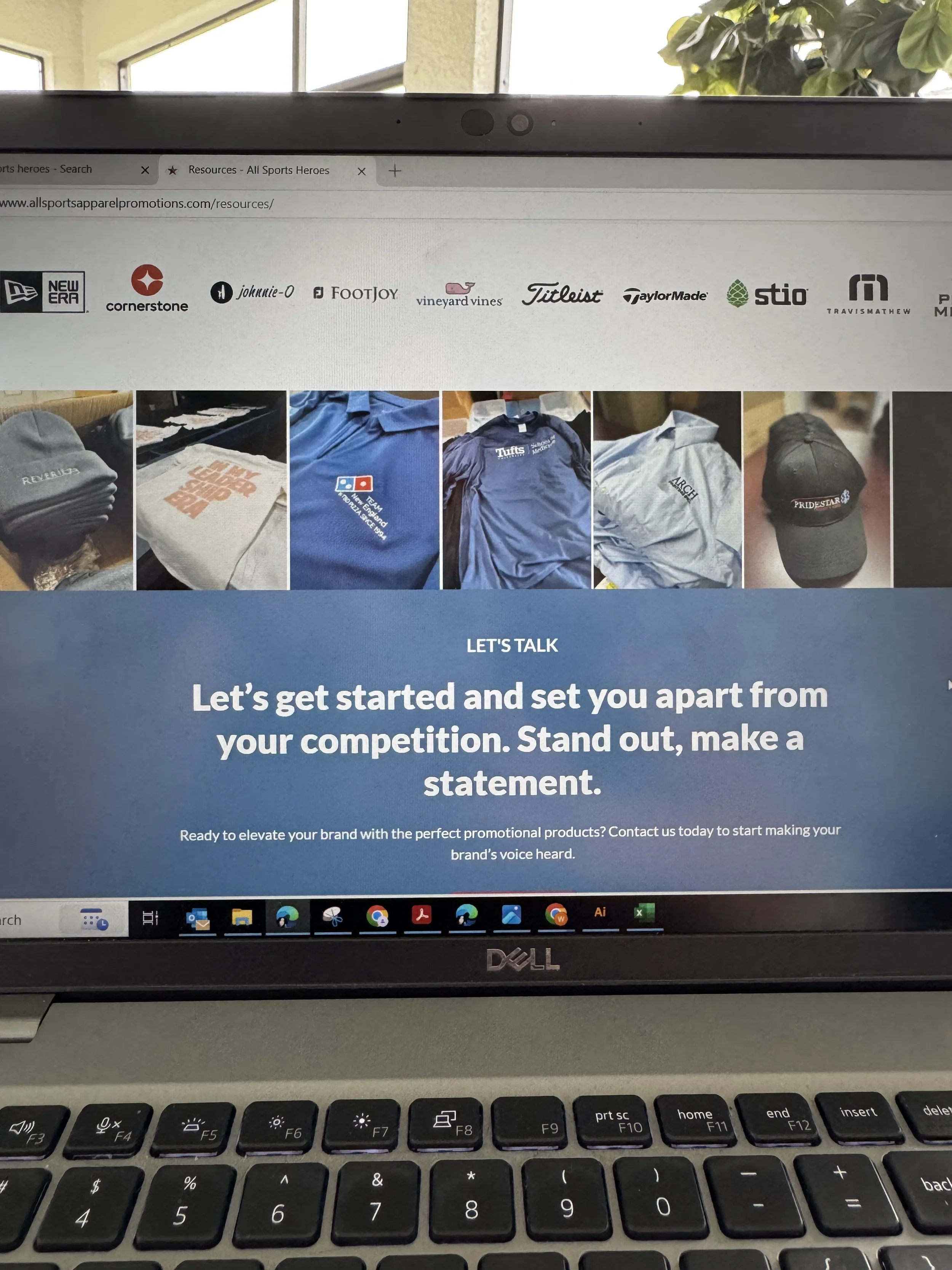 Computer screen displaying a website about promotional products, with images of branded apparel and accessories, and a message encouraging standing out and making a statement.
