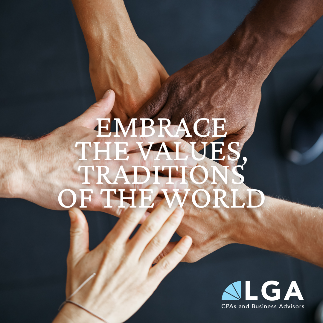 Several hands of different skin tones stacked together, symbolizing unity and diversity, with a message promoting embracing values and traditions of the world.