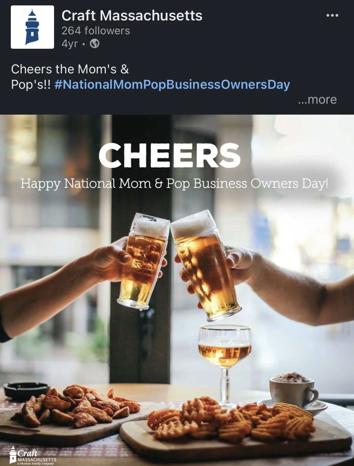 People clinking glasses of beer in celebration, with a table of fried food and snacks in the foreground, celebrating National Mom & Pop Business Owners Day.