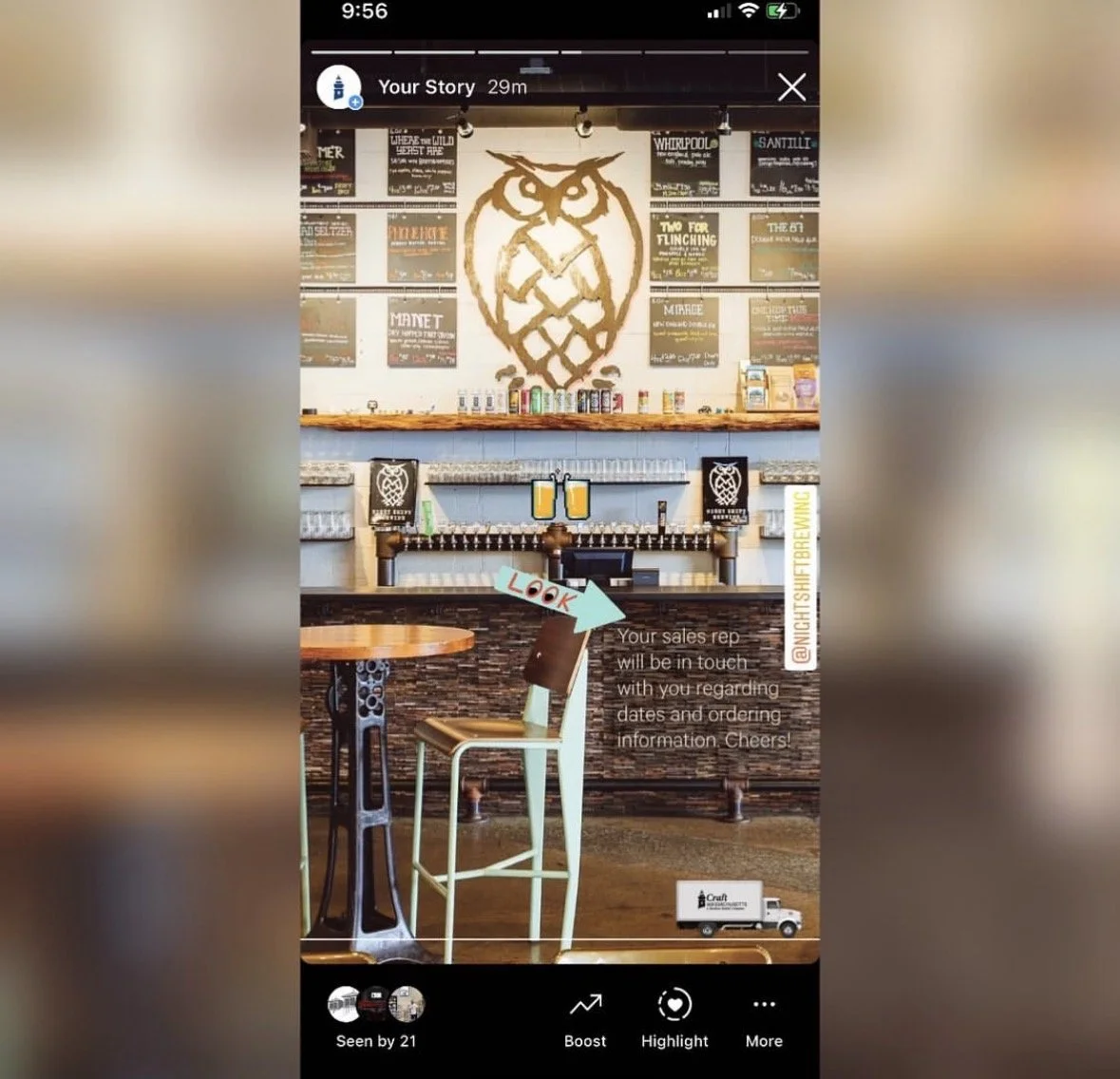Inside a brewery or bar with a large owl logo on the wall behind the bar counter, decorated with posters. There is a small table with a chair in the foreground, a digital overlay with the word ‘LOOK’ and an arrow pointing to the chair, and a miniatur