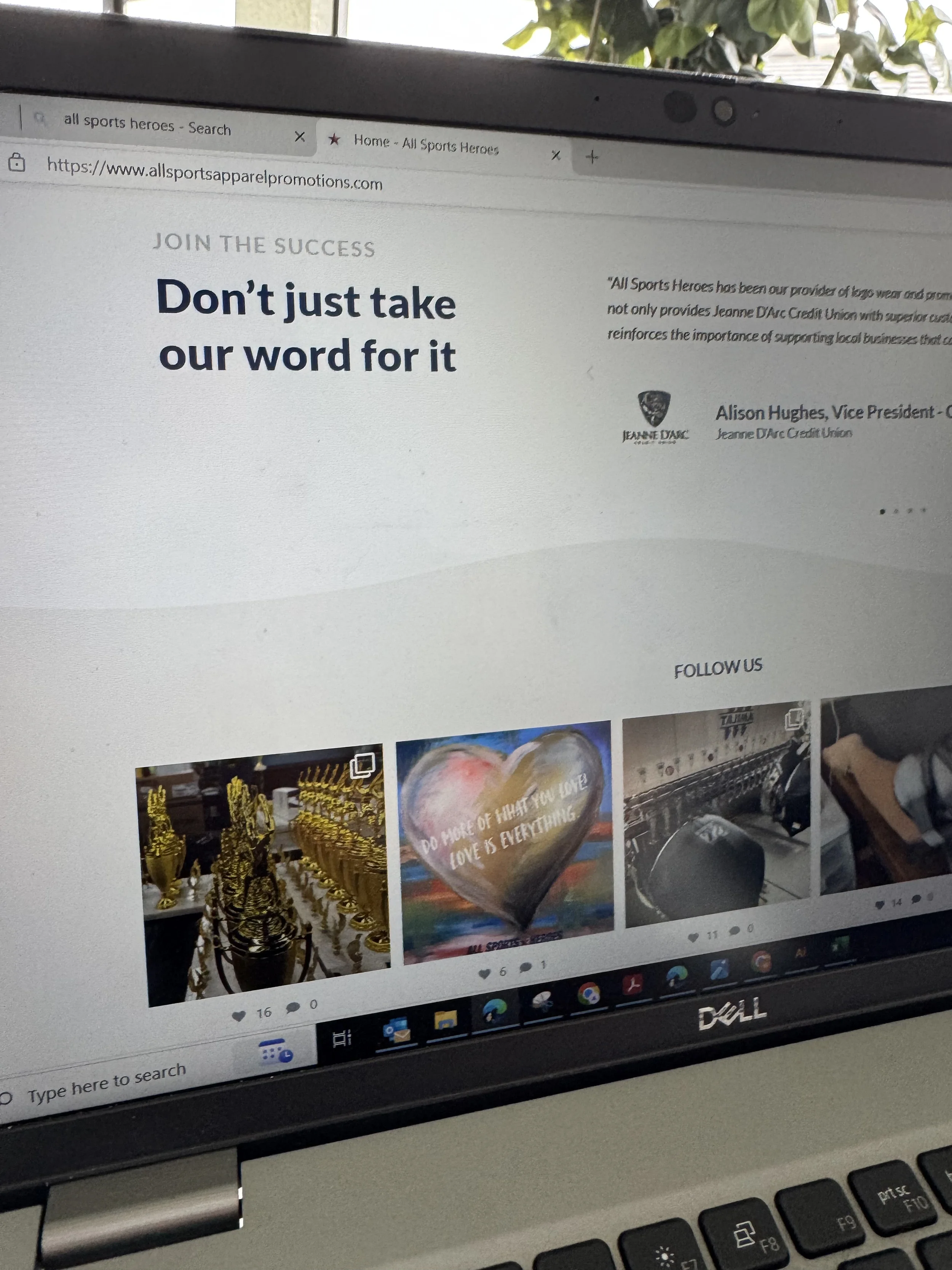 A computer screen displaying a website with images of trophies, a heart-shaped item with a quote, and a motorcycle.