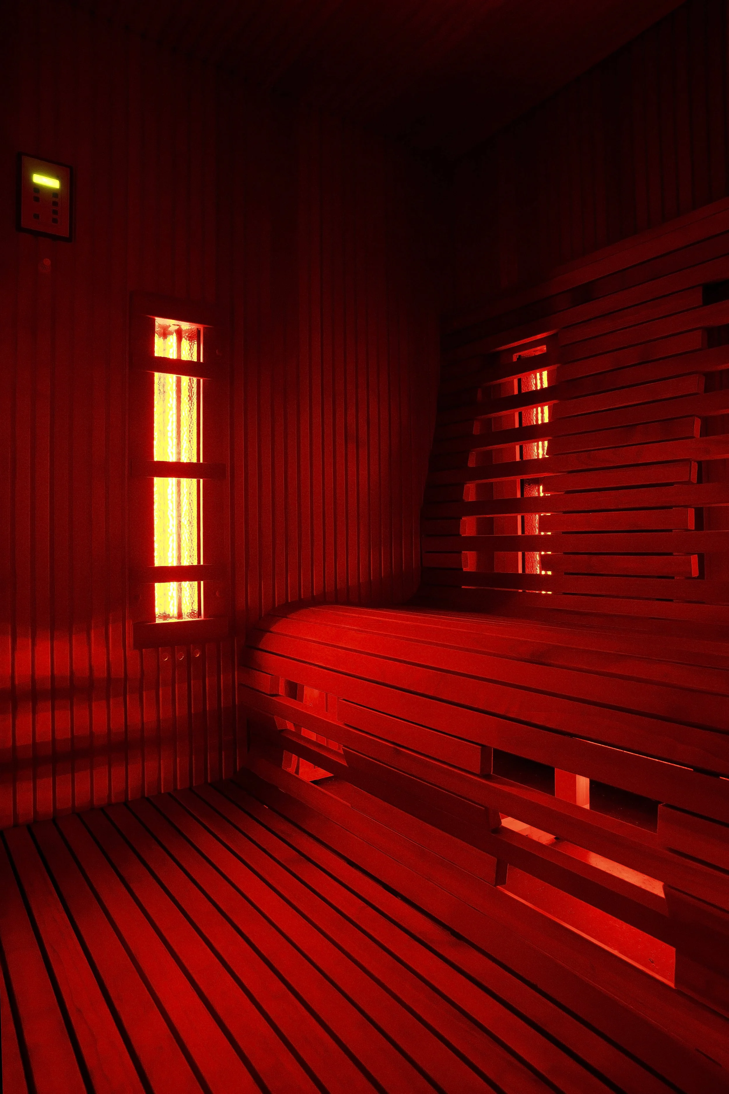 Infrared sauna interior with wood bench seating and red light therapy