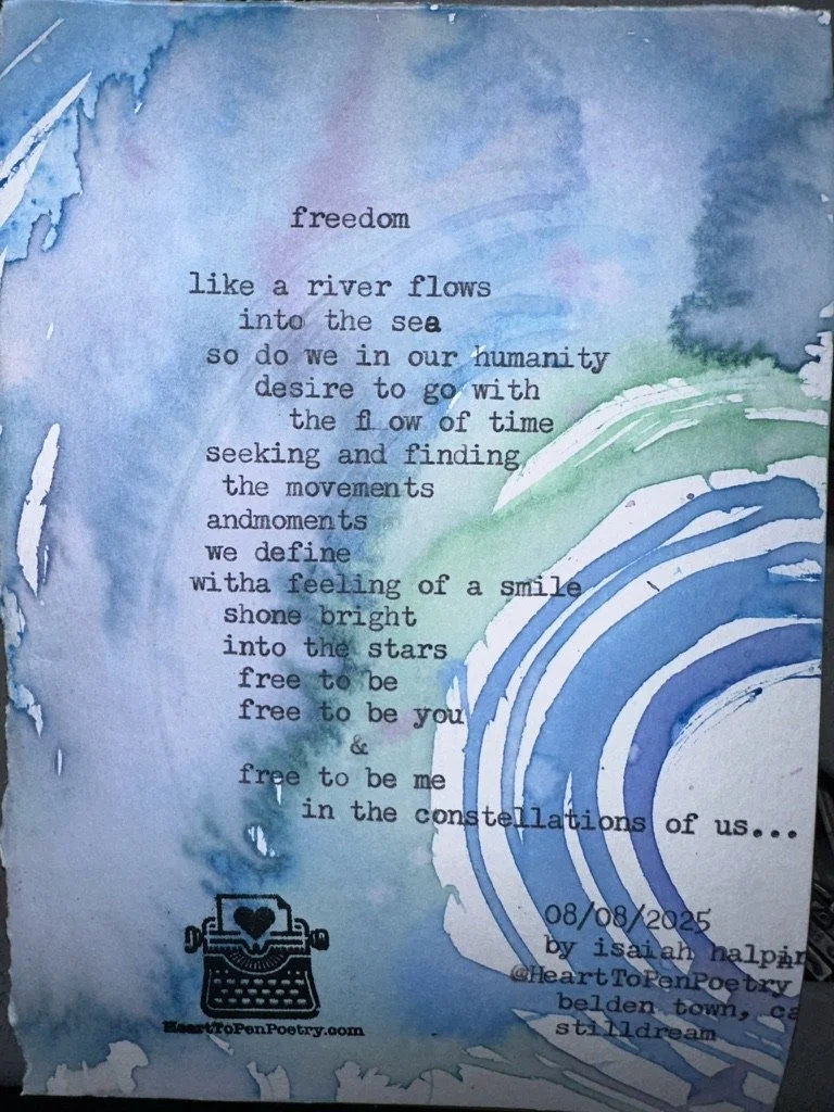 A watercolor painting with shades of blue, green, and purple. Text overlaid features a poem about freedom, movement, and stars. A small illustration of a typewriter with a heart on the paper is near the bottom, alongside the website 'HeartToPenPoetry