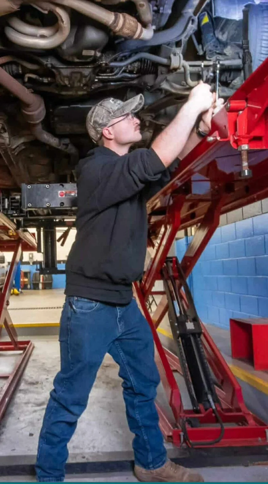 Auto repair technician working on vehicle in Laconia NH