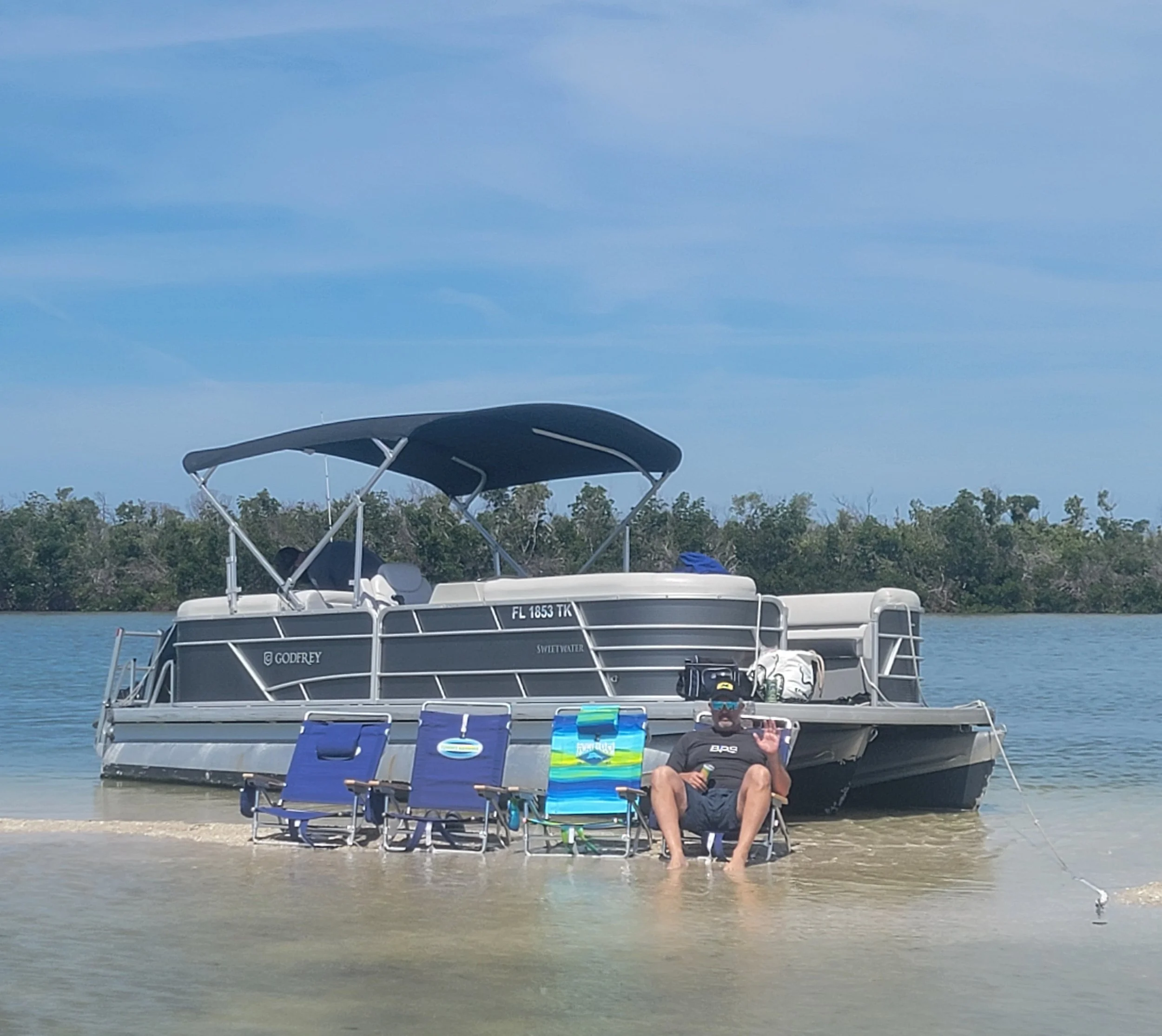 Beach Chairs next to Pontoon Boat on a Sandbar