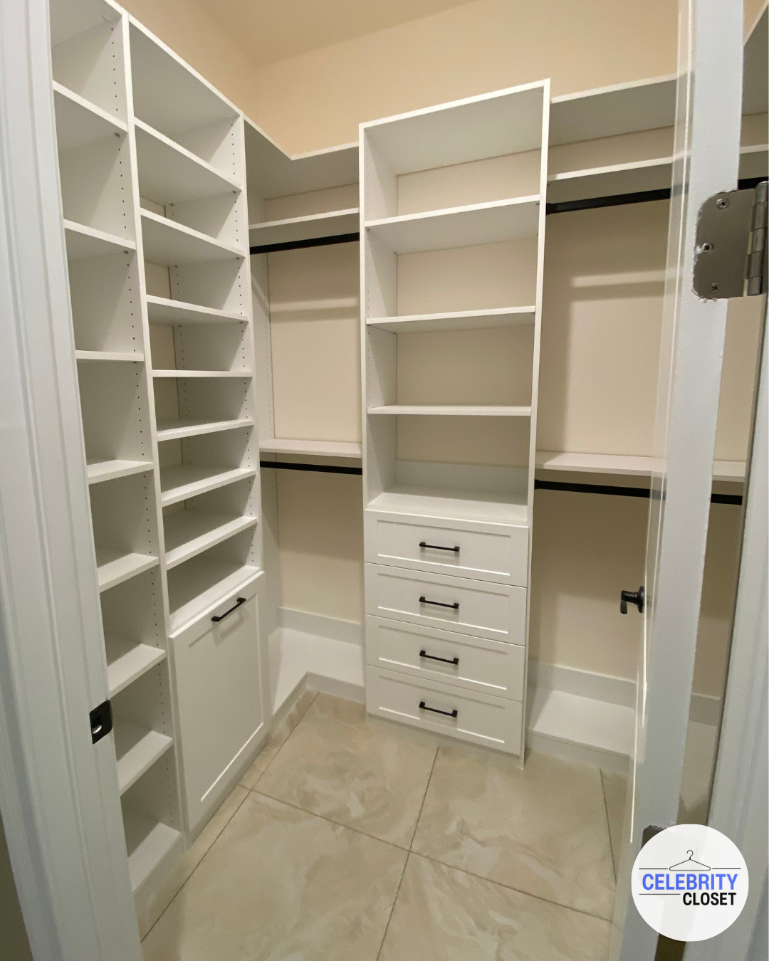 Empty white closet with multiple shelves, drawers, and hanging rods on beige walls.