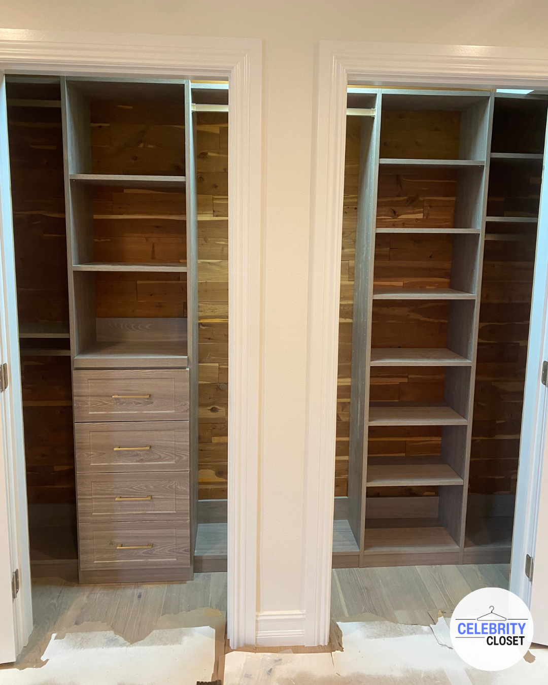 Two open closet spaces with wooden shelving and drawers, with a wood-paneled background and white trim around the doors.