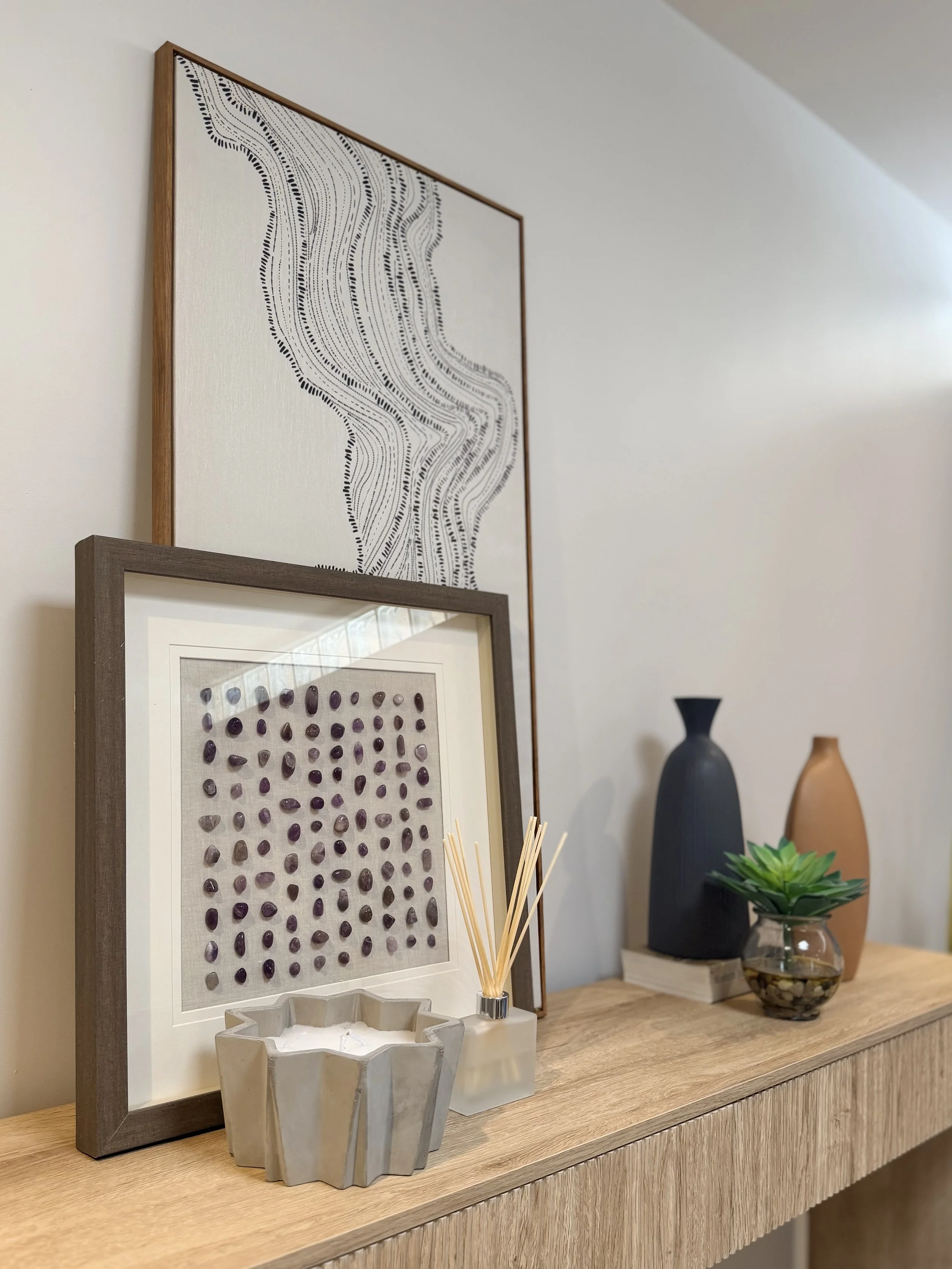 Styled decor vignette at Green Orange Studio, a warm North Phoenix creative studio rental with art, candles, greenery, and modern details.