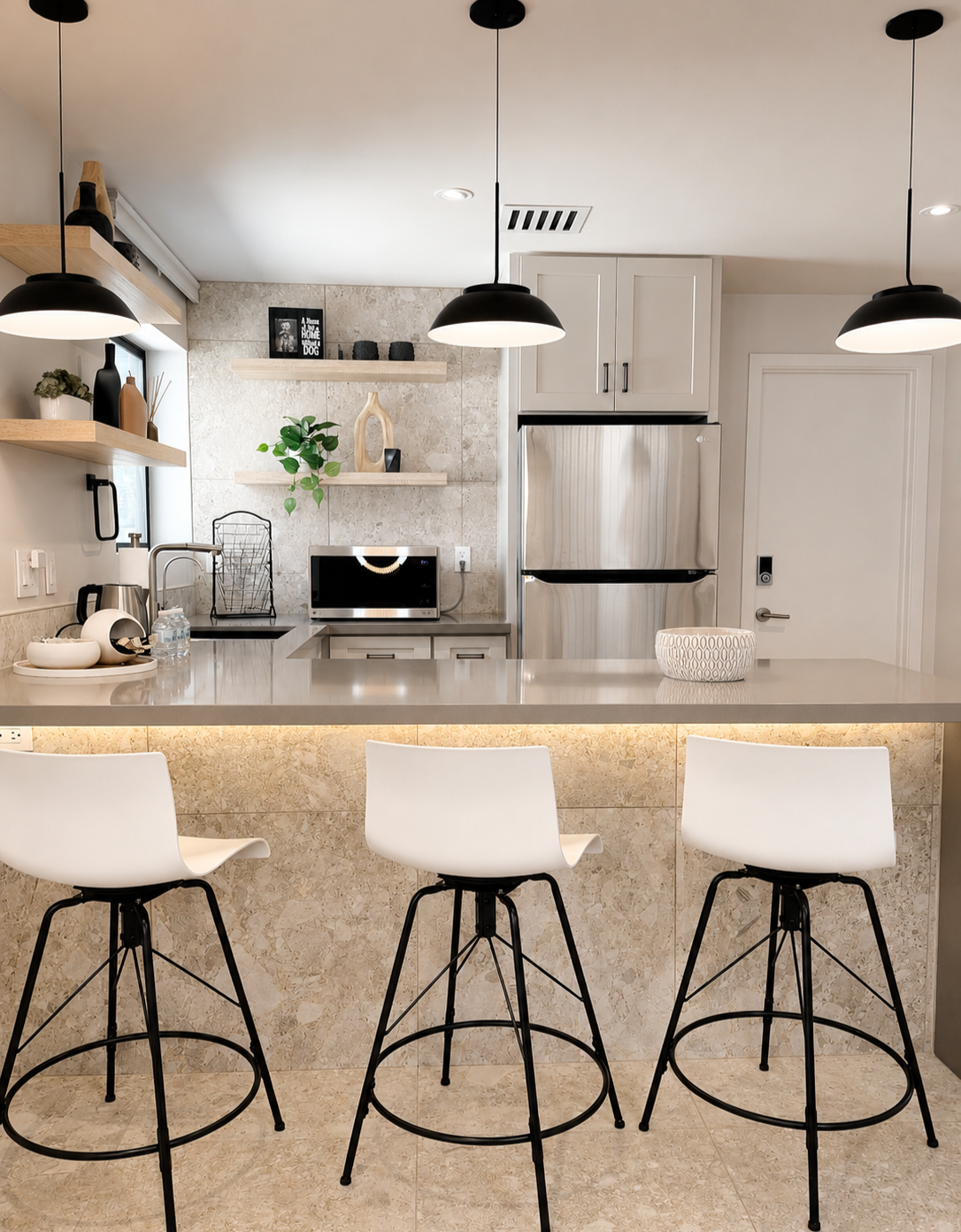 Styled kitchen backdrop at Green Orange Studio with white cabinets, bar stools, pendant lights, and modern details for photo and video shoots.