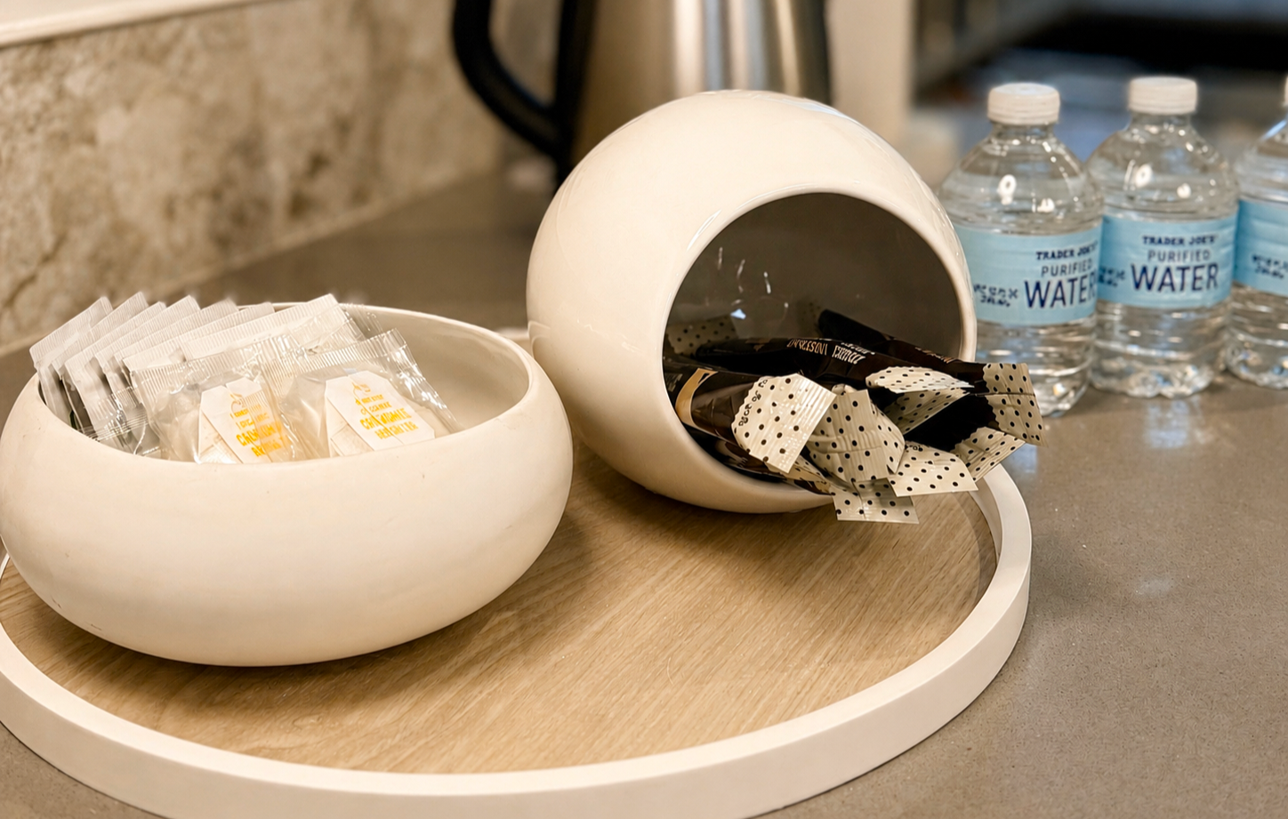 Guest refreshment station at Green Orange Studio with coffee, creamer, sugar, and bottled water for studio rentals and creative sessions.