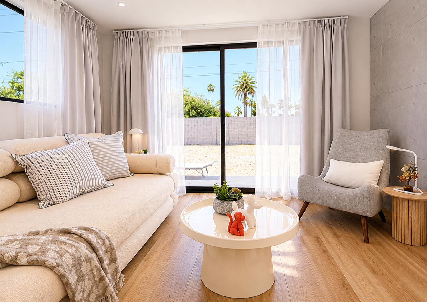 Bright living room studio setup at Green Orange Studio with sleeper sofa, natural light, patio views, and flexible space for photography, content creation, meetings, or rest.