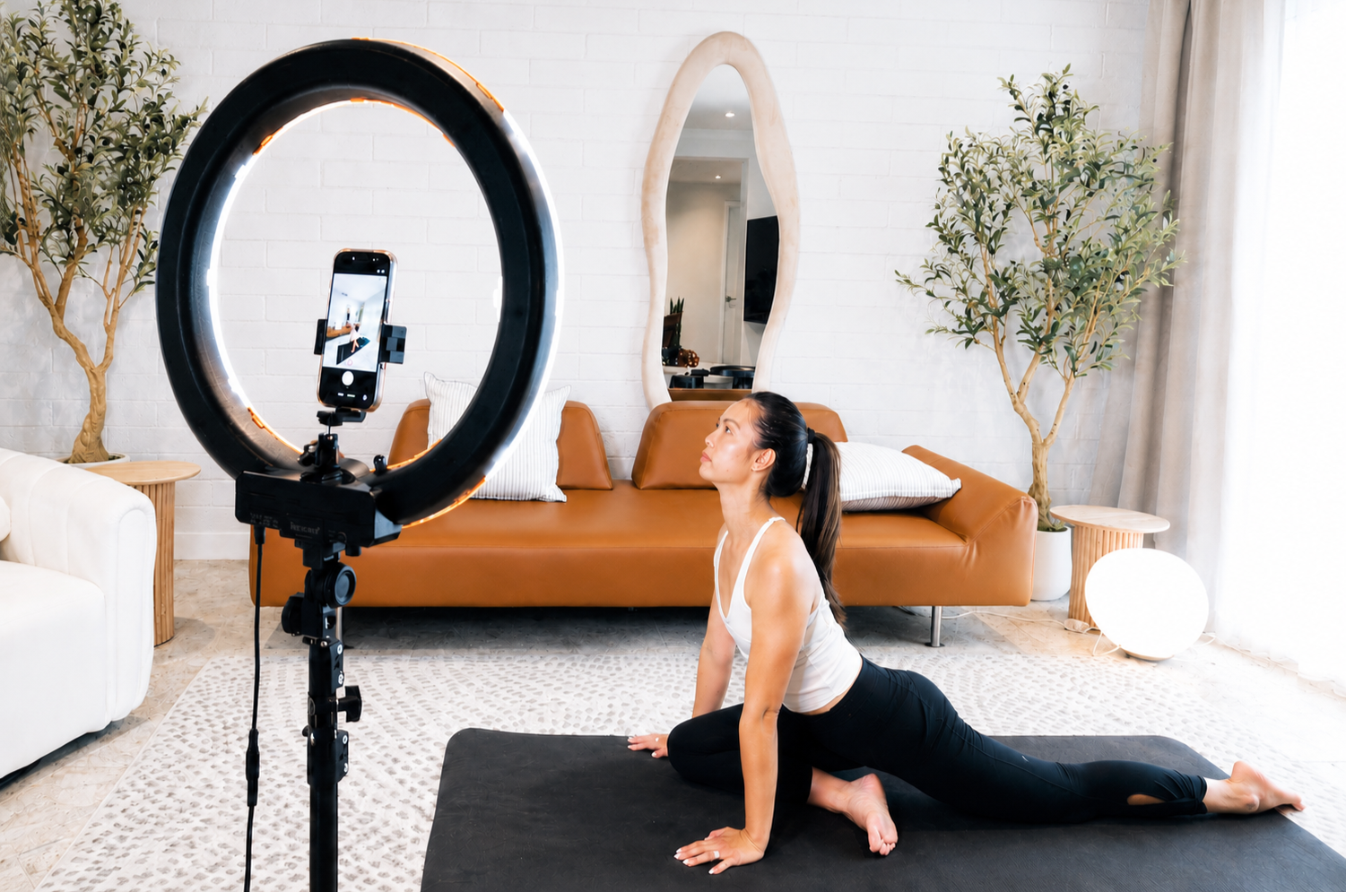 Wellness content setup at Green Orange Studio with yoga mat, ring light, mirror, and peaceful North Phoenix studio space for video recording.