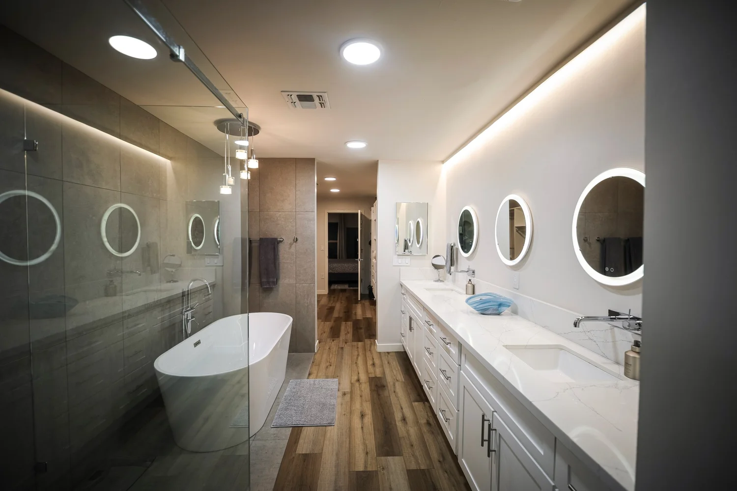 Primary bathroom with a freestanding soaking tub, walk-in shower and double vanity.