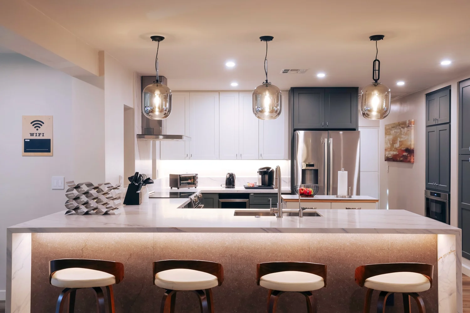 Modern kitchen with a waterfall island and seating for four.