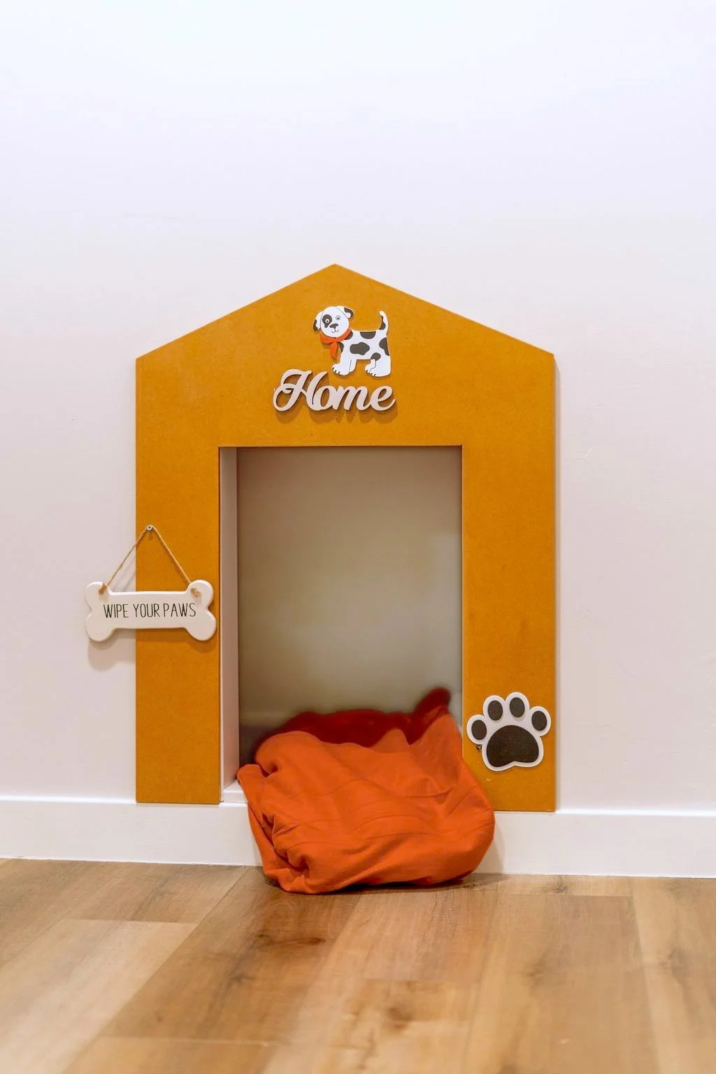 Pets are welcome! A cozy dog-bedroom nook with an orange cushion sits beside the office.