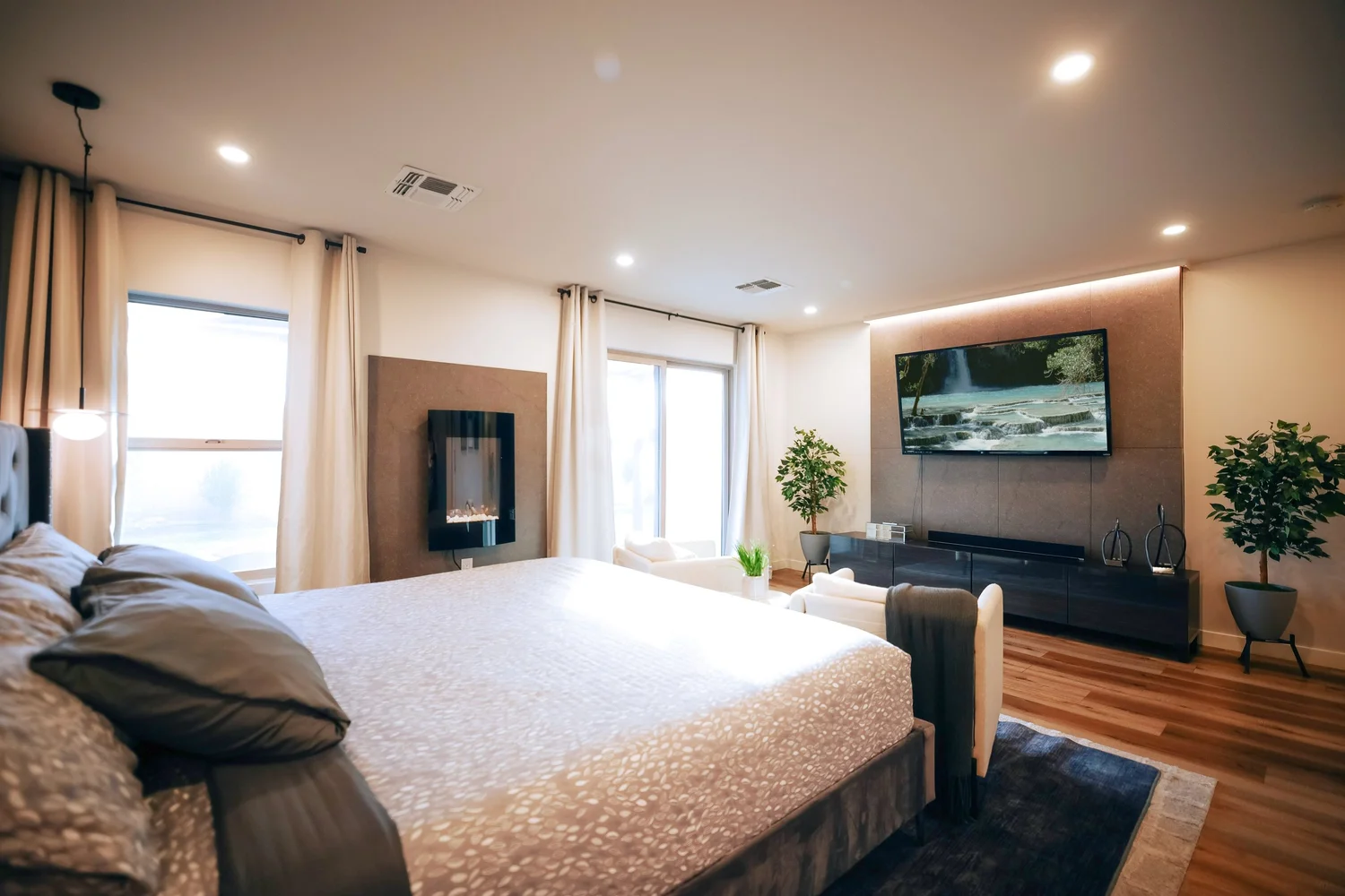 Primary king suite with a fireplace, TV and a separate sitting area.