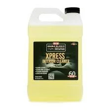 A large container of Xpress interior cleaner, yellow liquid, with a black and green label.