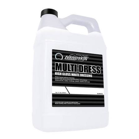 A large white container of NanoSkin multi-dress high gloss white dressing with a black cap and black label.