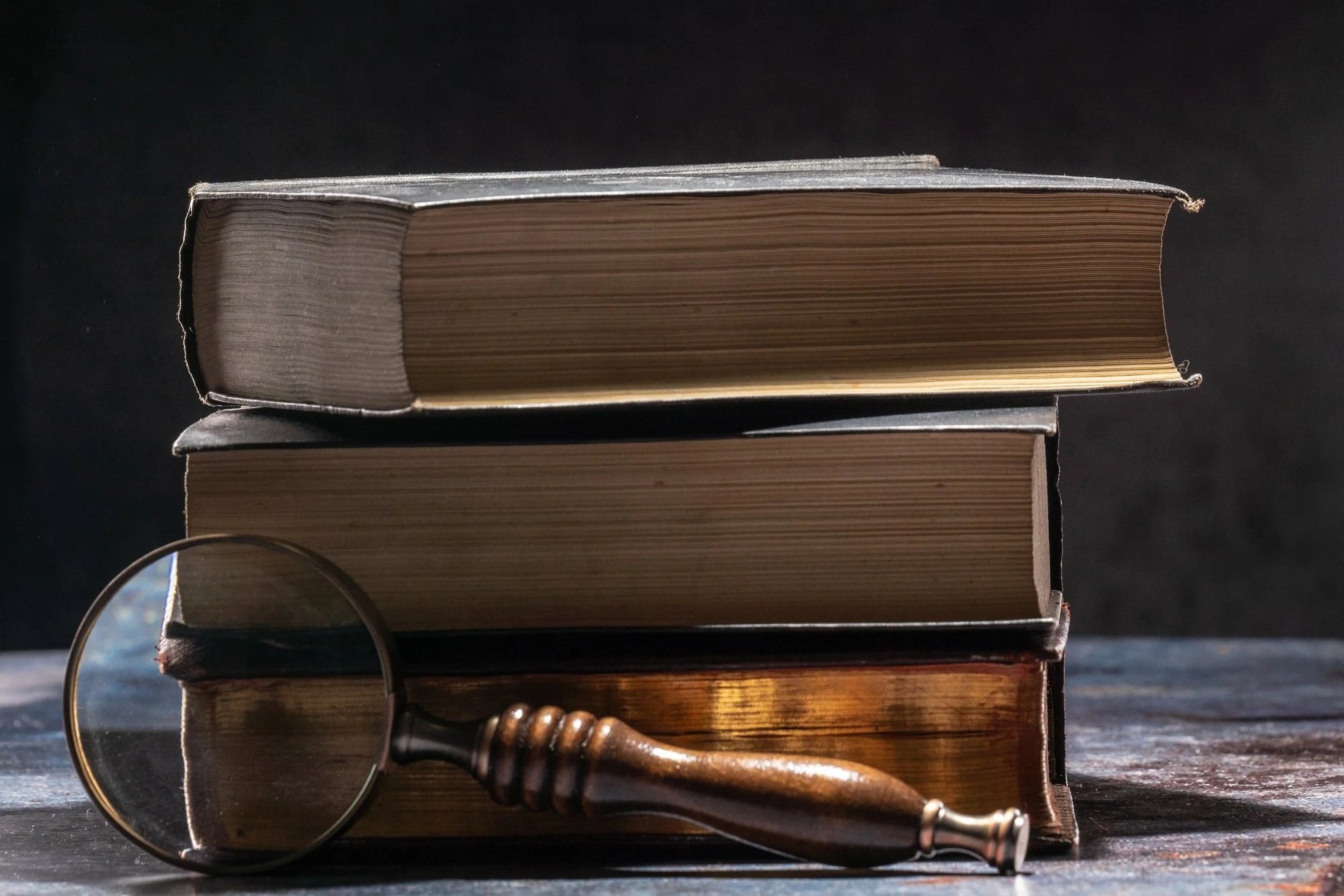 vintage-books-and-magnifying-glass-on-dark-surface-2026-03-16-01-15-29-utc.jpg