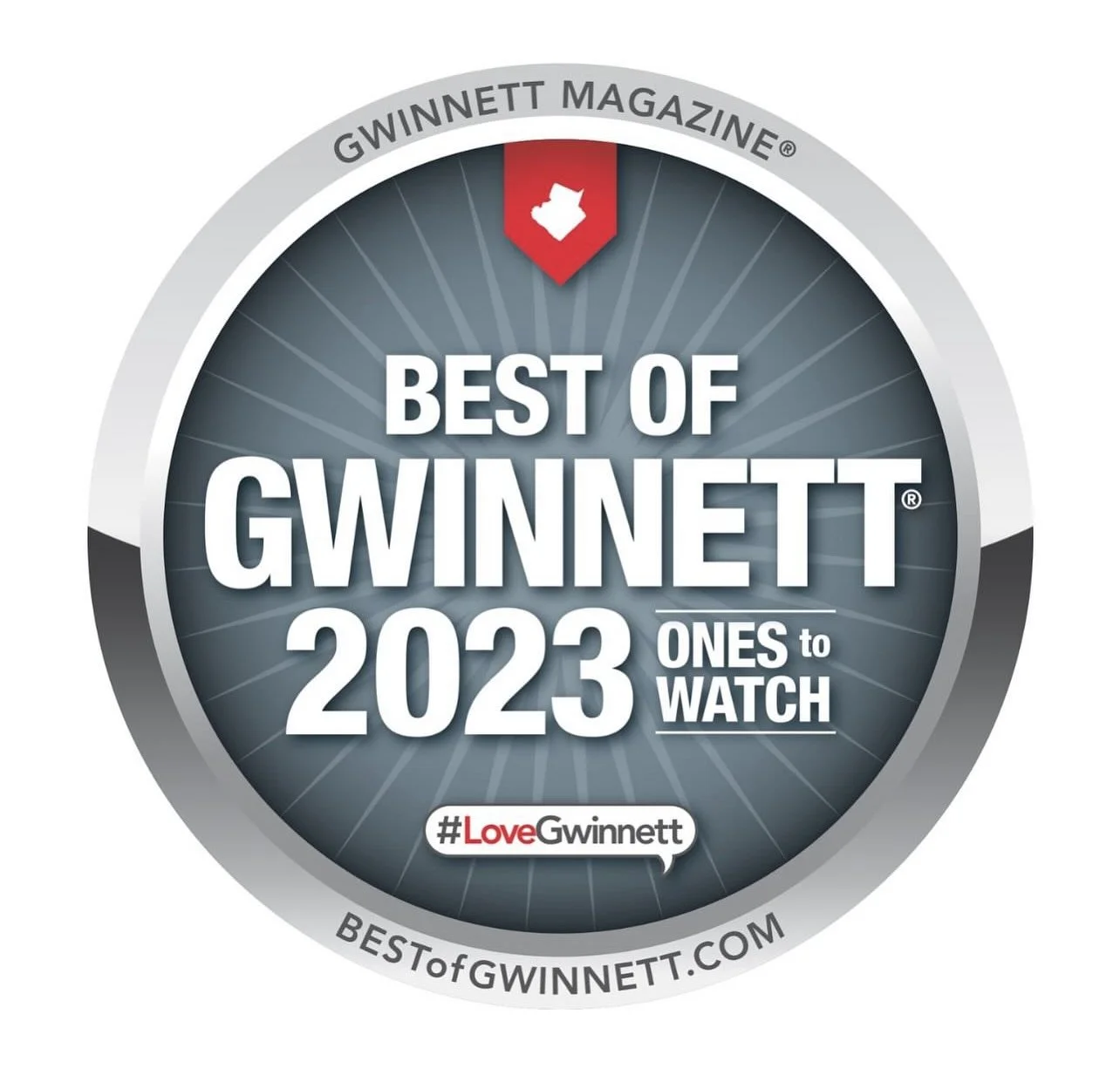 Badge for 'Best of Gwinnett 2023,' recognizing top local places to watch, featuring a gray border, a red arrow with a white Georgia state shape, and the hashtag #LoveGwinnett.