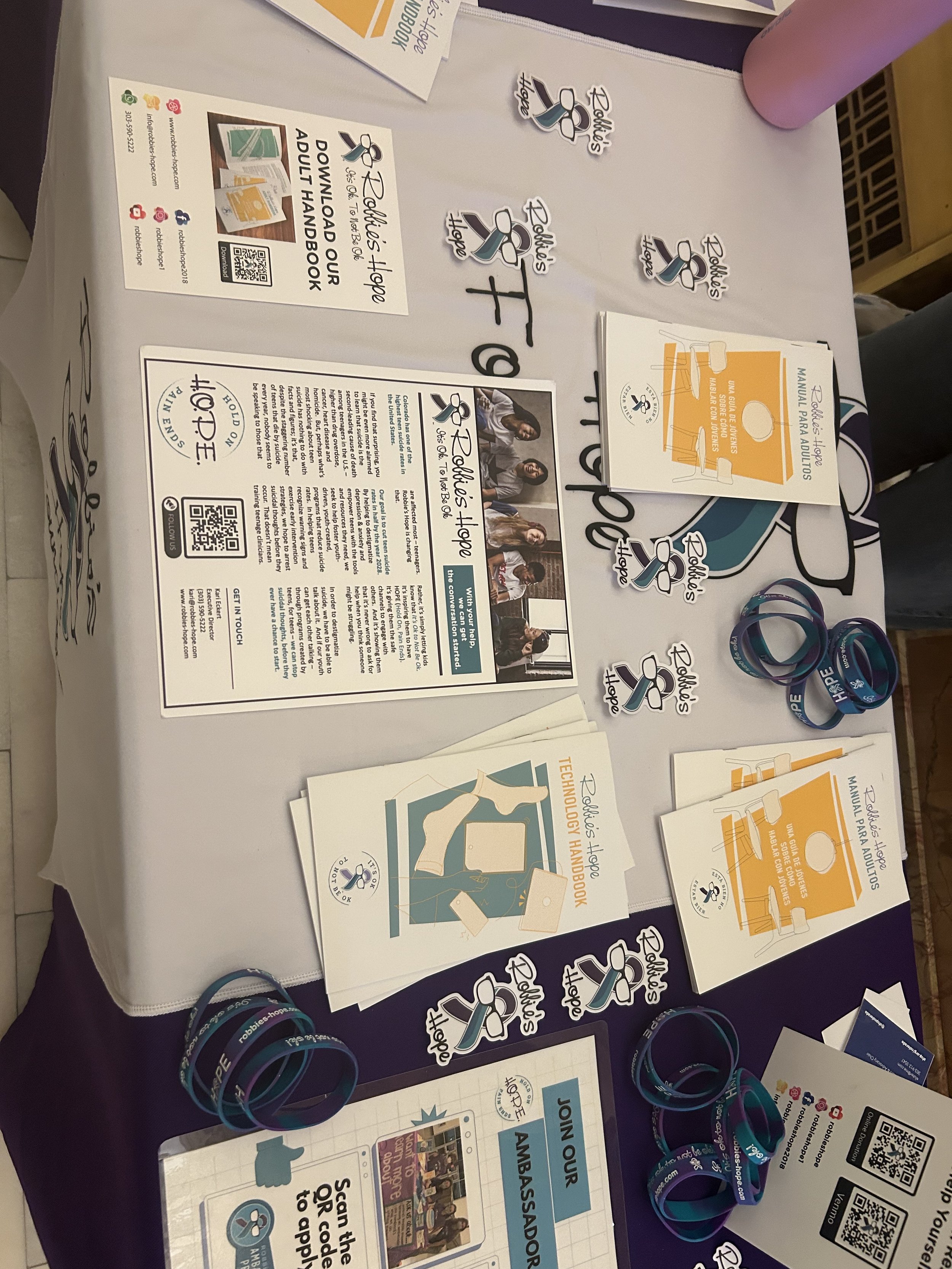 Robbie’s Hope handbooks, stickers, and conversation resources on display.
