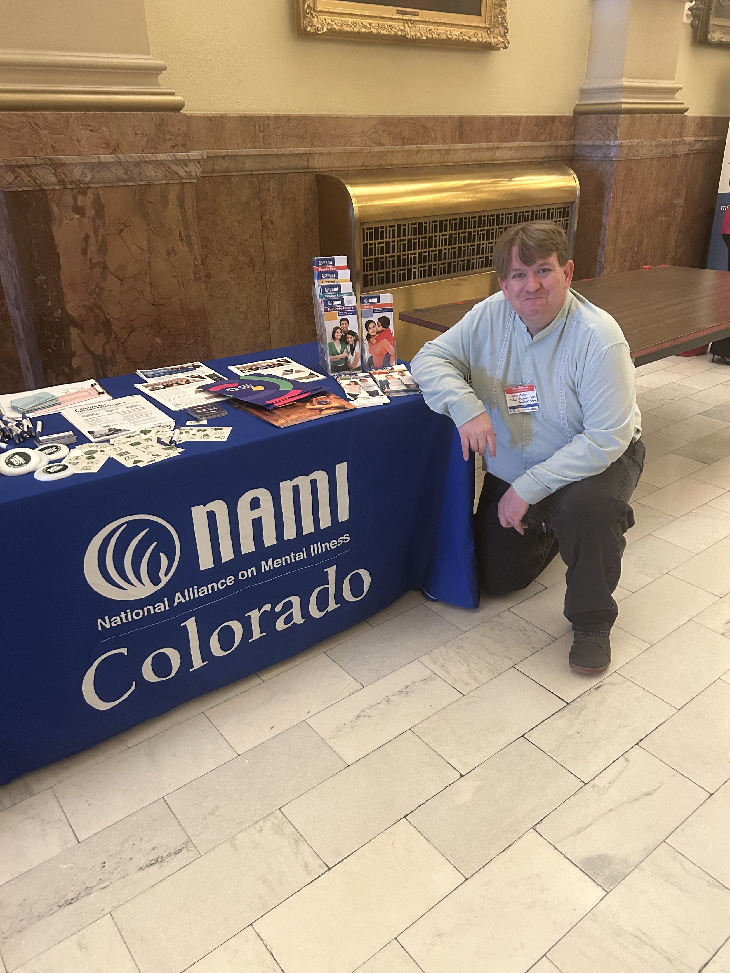 NAMI Colorado representative at a community mental-health resource table.