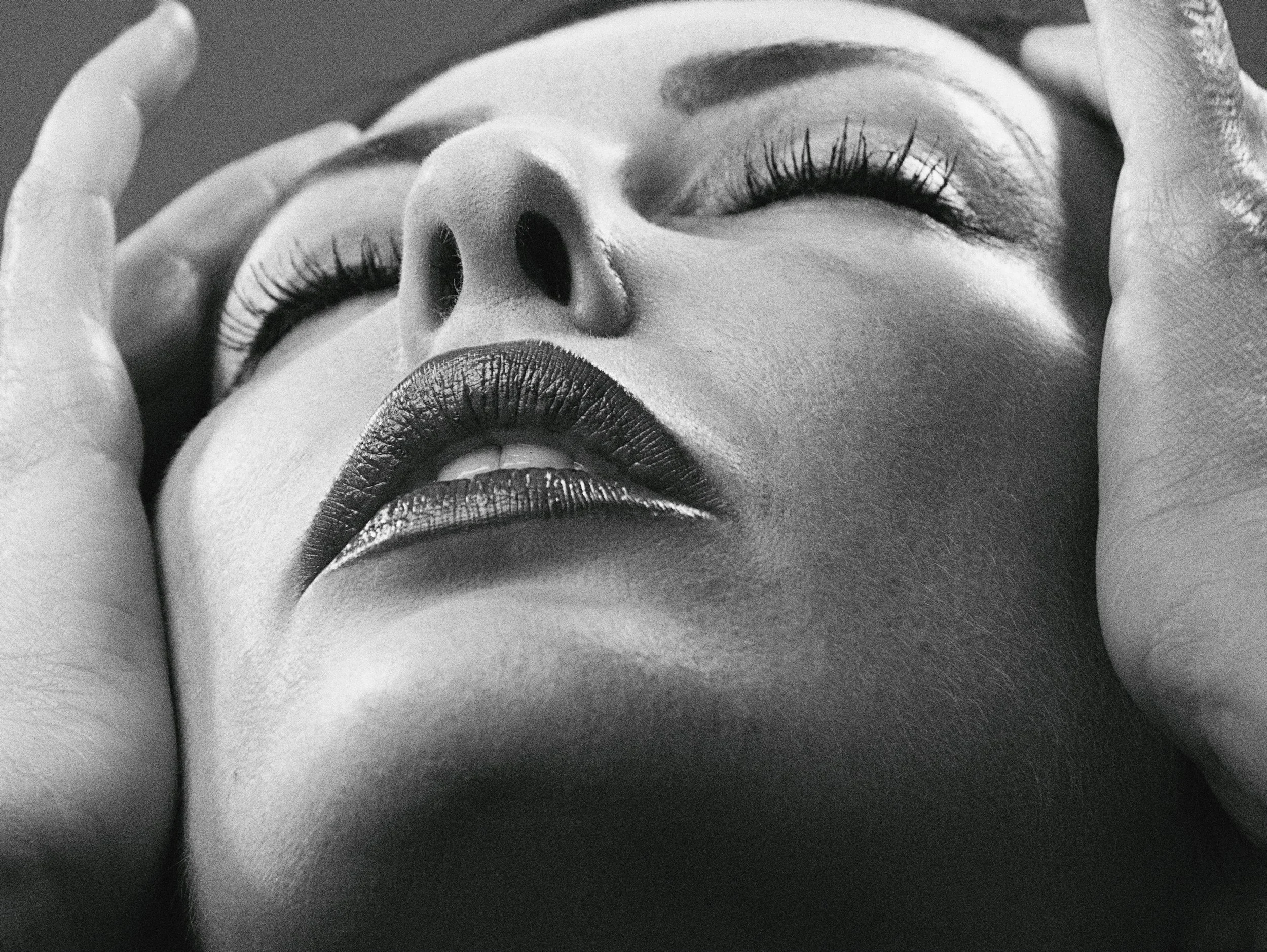 A client experiencing a deep state of relaxation during an Elyon Boutique Spa facial treatment.